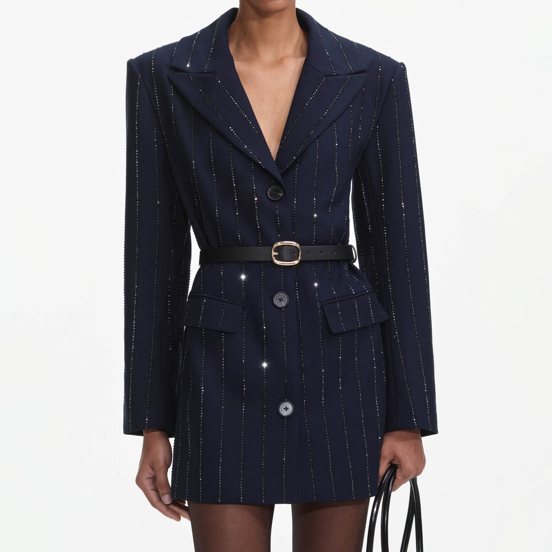 A close up of a woman wearing the Navy Rhinestone Pinstripe Blazer