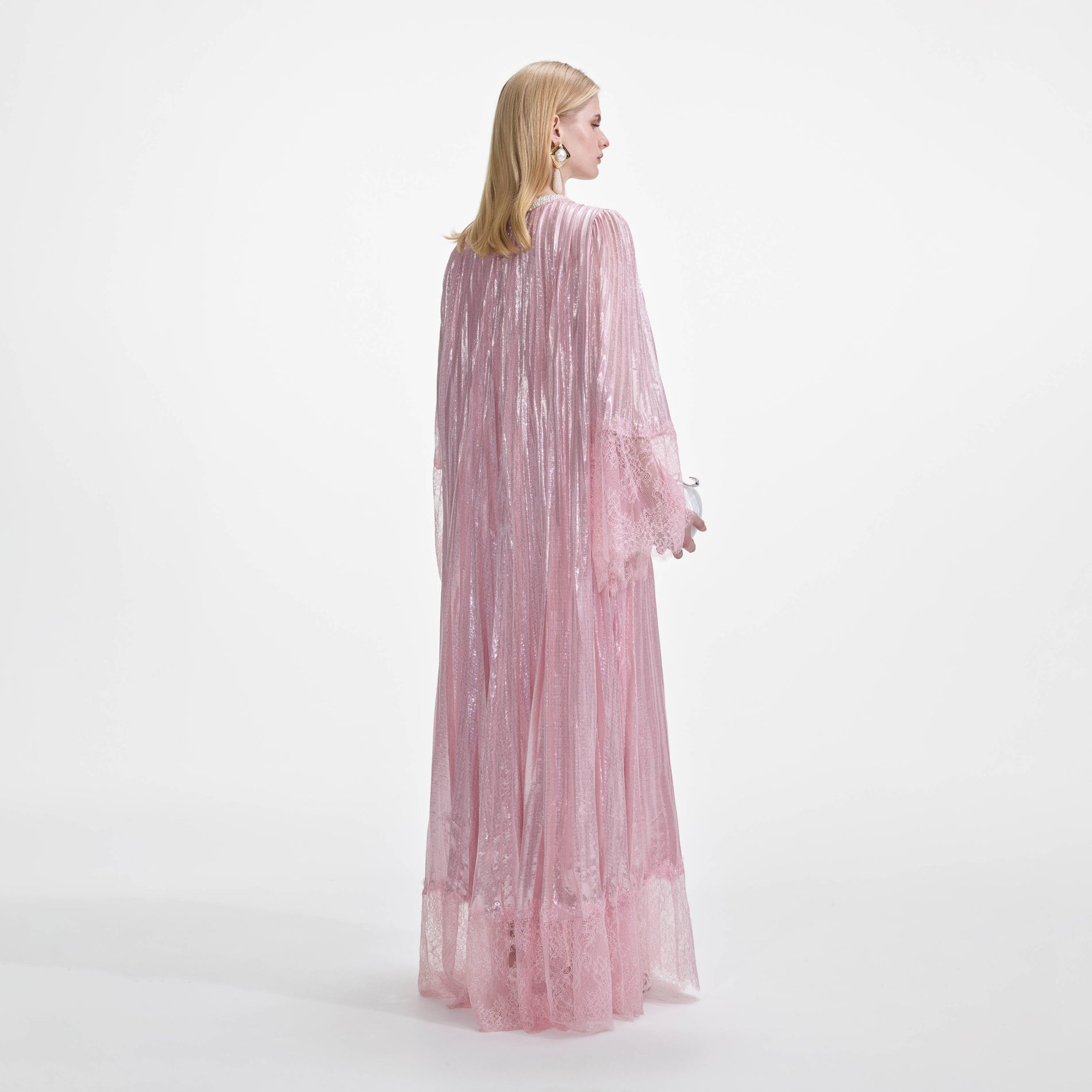 Side view of a woman wearing the Pink Metallic Pearl Maxi Dress