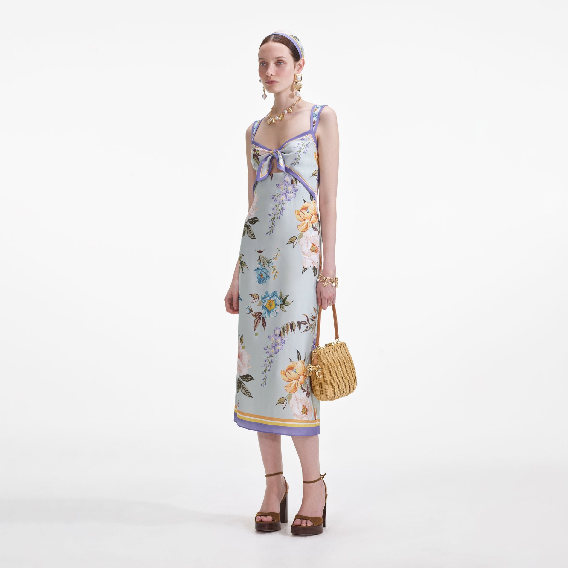 Side view of a woman wearing the Blue Floral Silk Twill Midi Dress