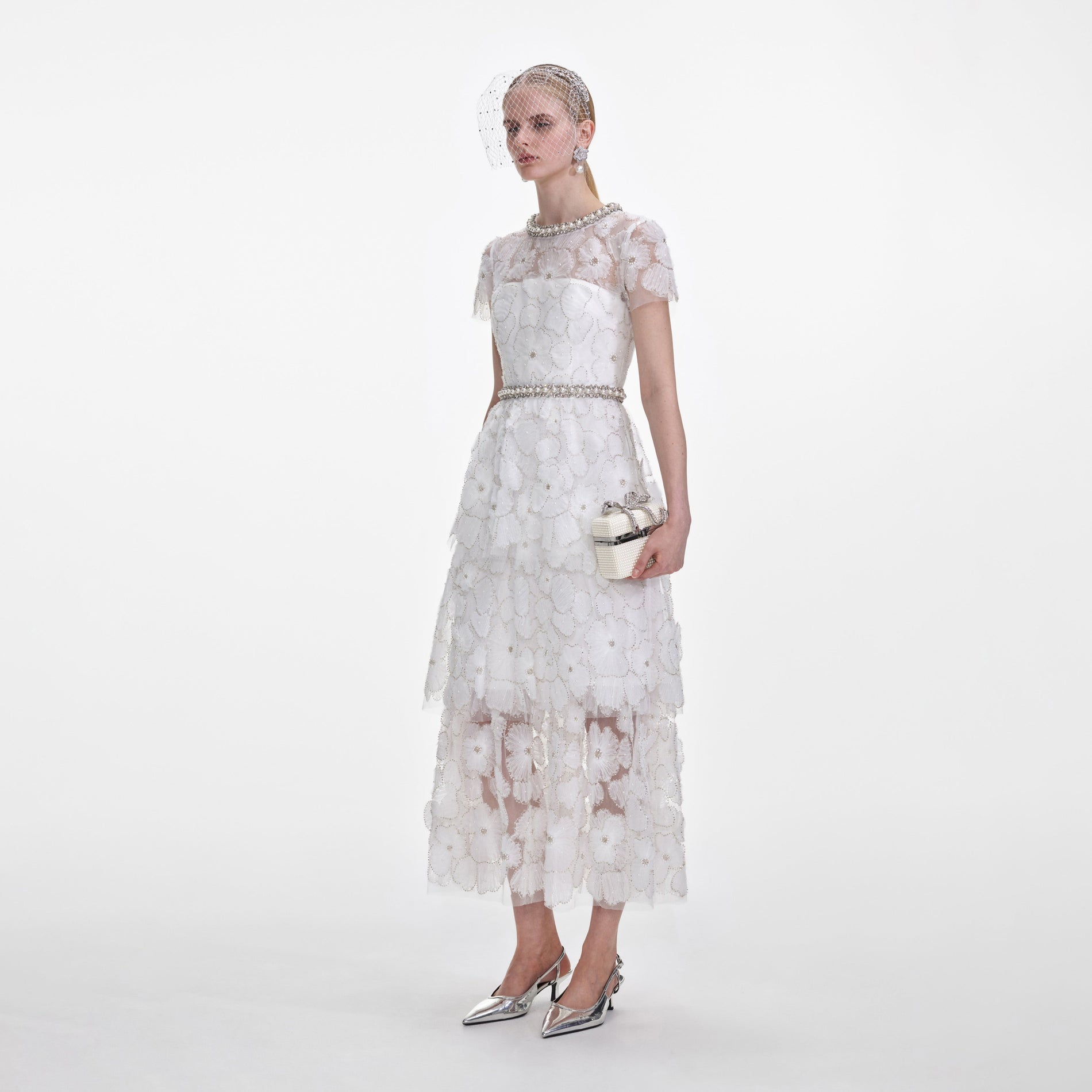 Side view of a woman wearing the White Embellished Tulle Tiered Midi Dress