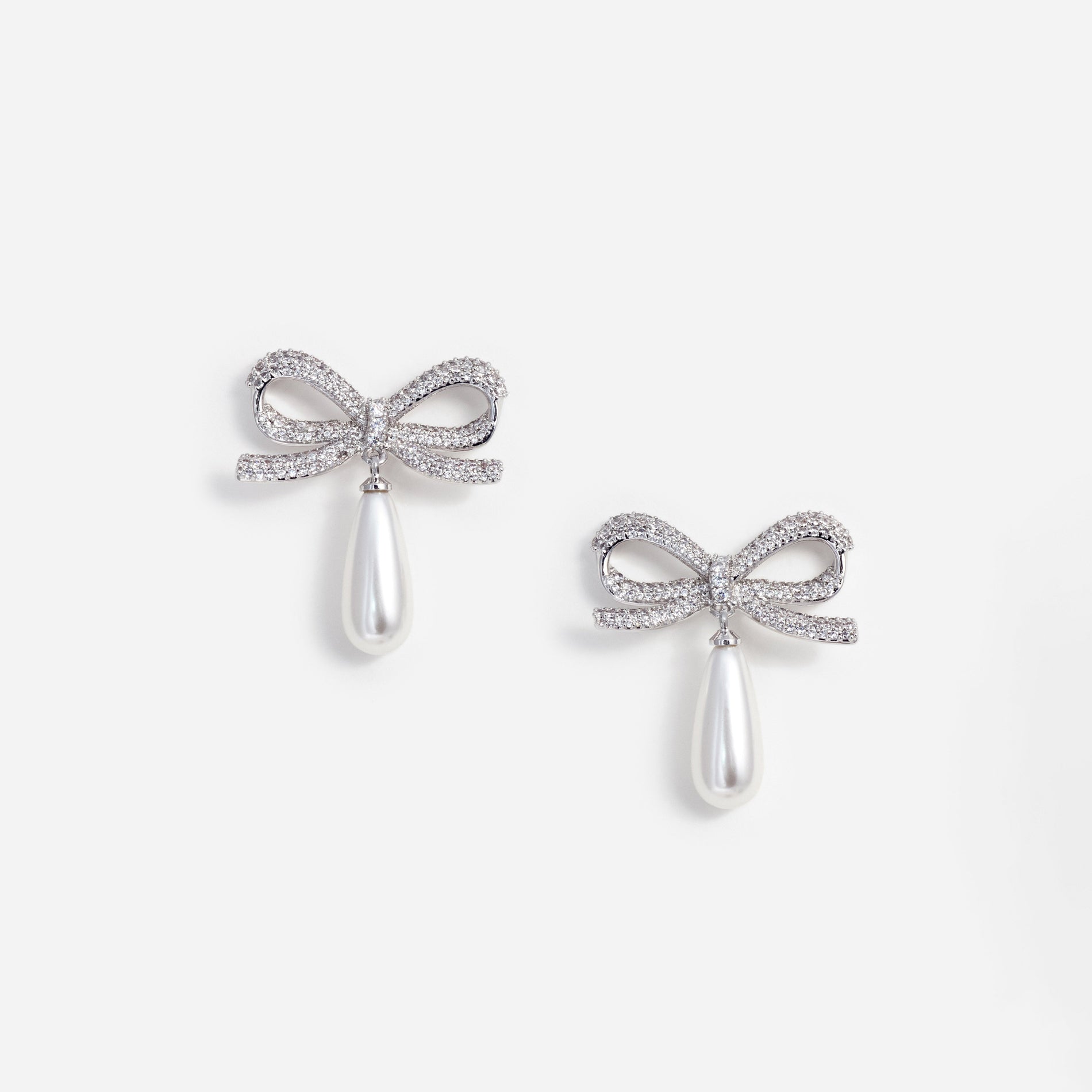 A photo of the Crystal Bow Pearl Droplet Earrings