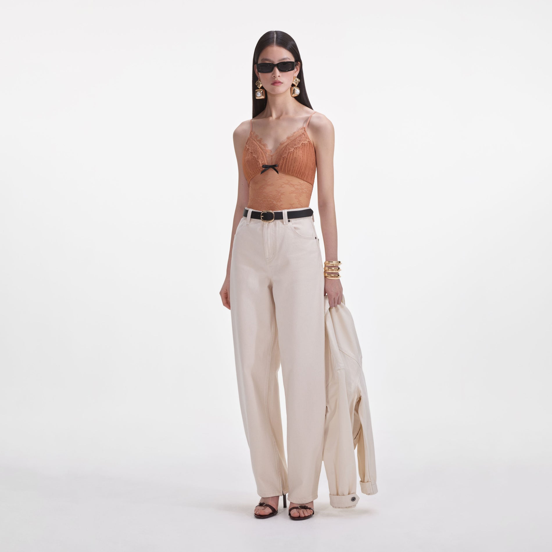 Side view of a woman wearing the Cream Denim Jeans