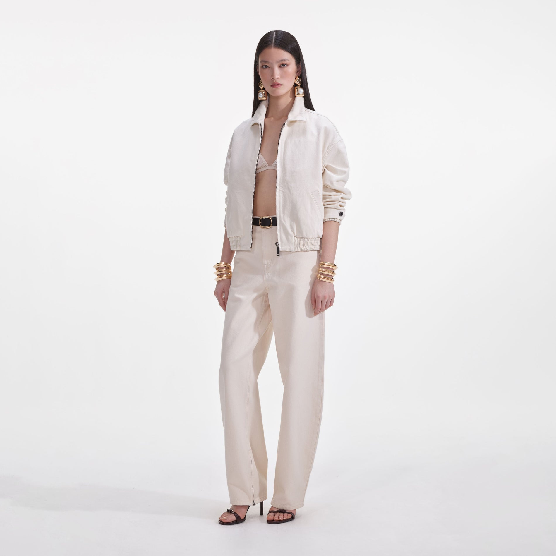 Side view of a woman wearing the Cream Lightweight Denim Jacket