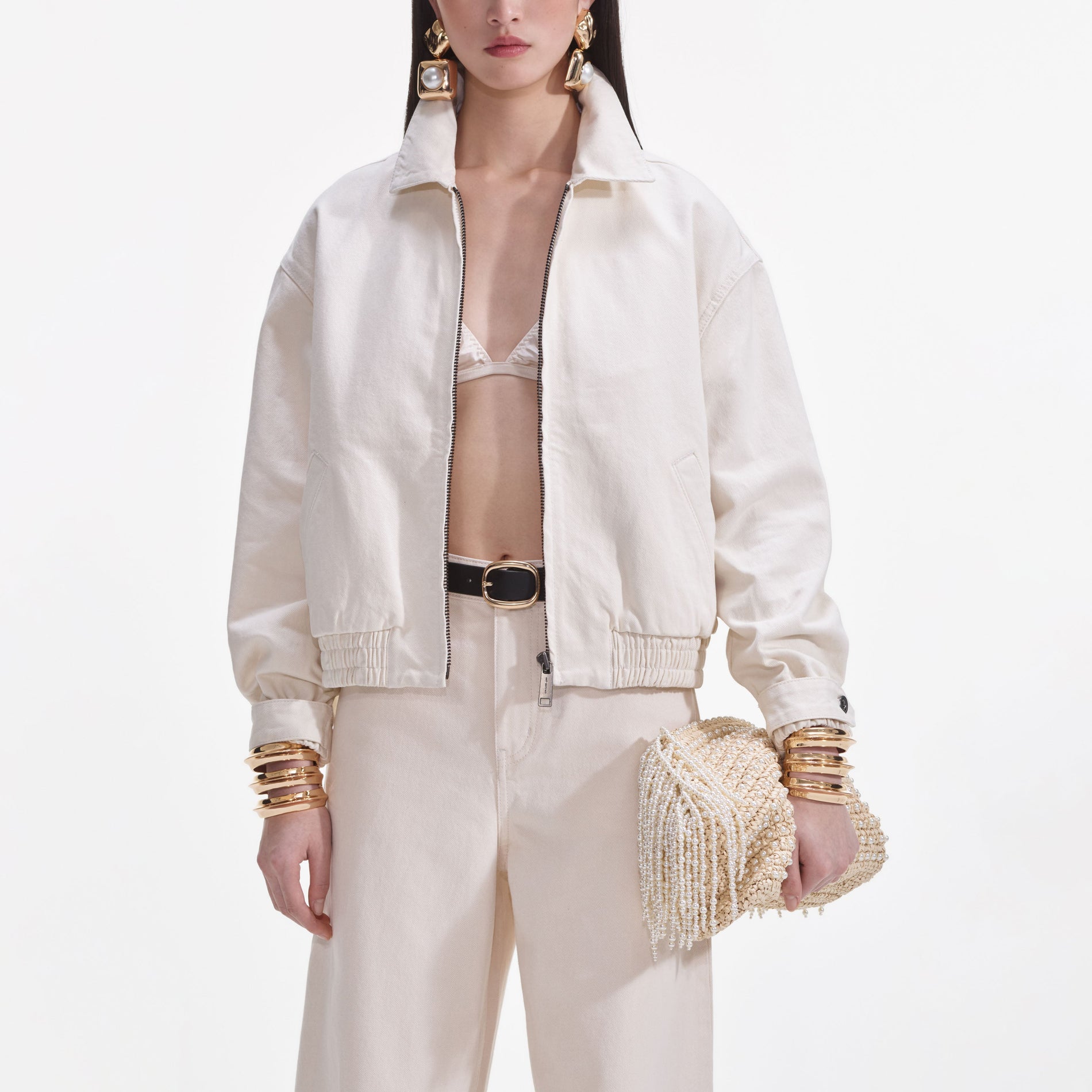 Side view of a woman wearing the Cream Lightweight Denim Jacket