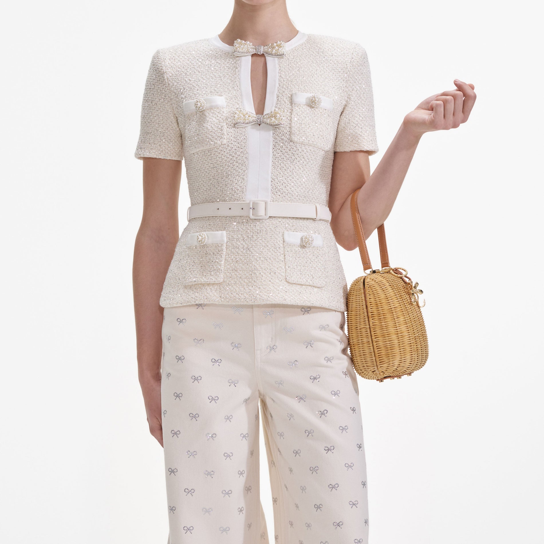 A close up of a woman wearing the Cream Sequin Knit Top