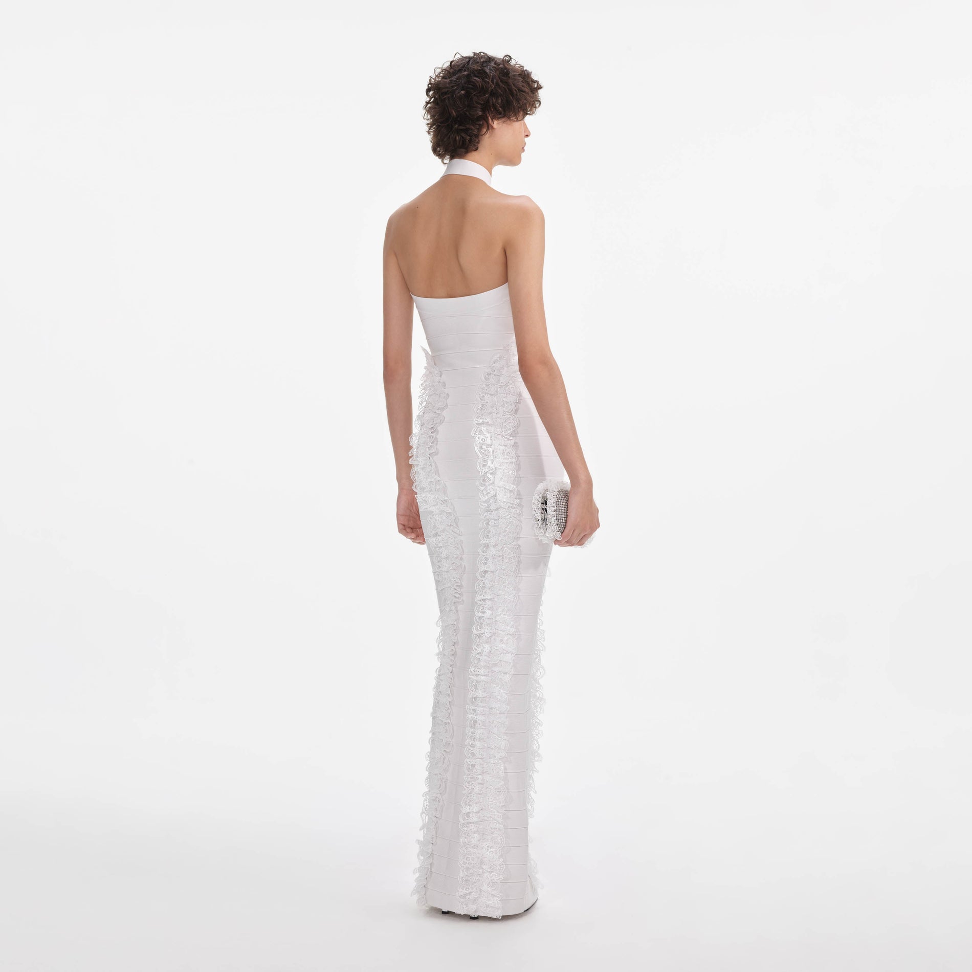 Back view of a woman wearing the White Knit Zip Ruffle Maxi Dress