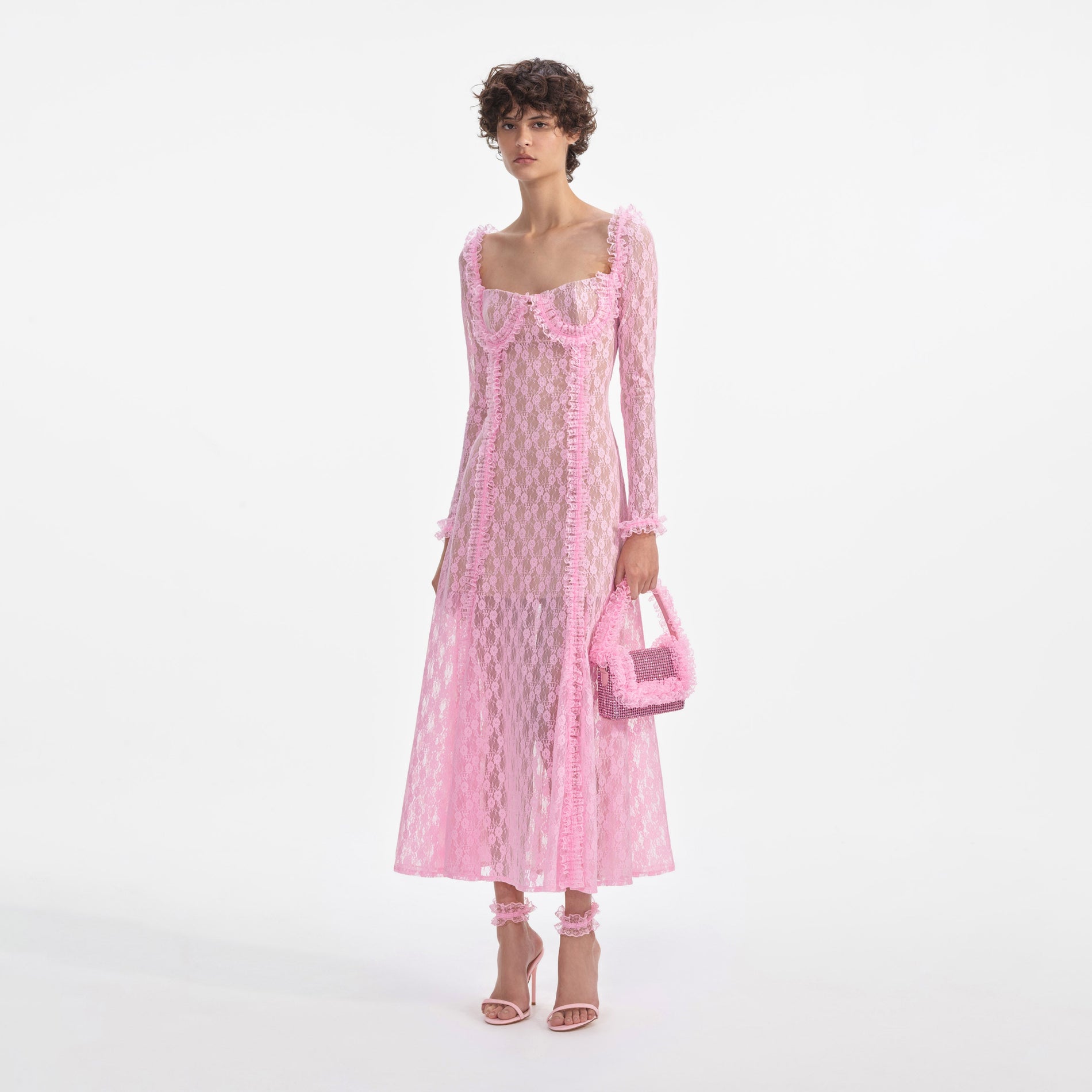 Side view of a woman wearing the Pink Lace Ruffle Midi Dress