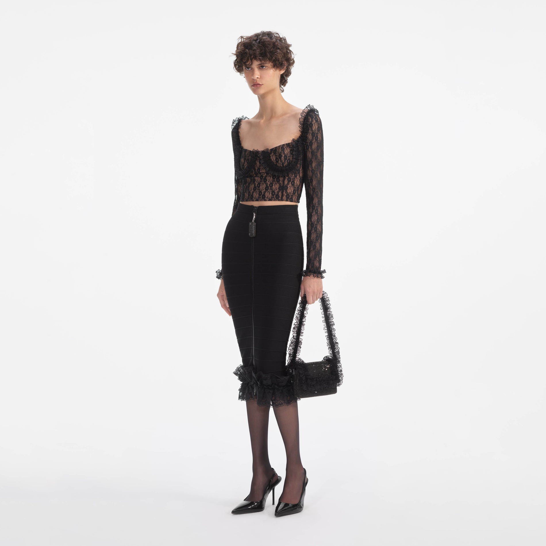 Side view of a woman wearing the Black Lace Ruffle Top