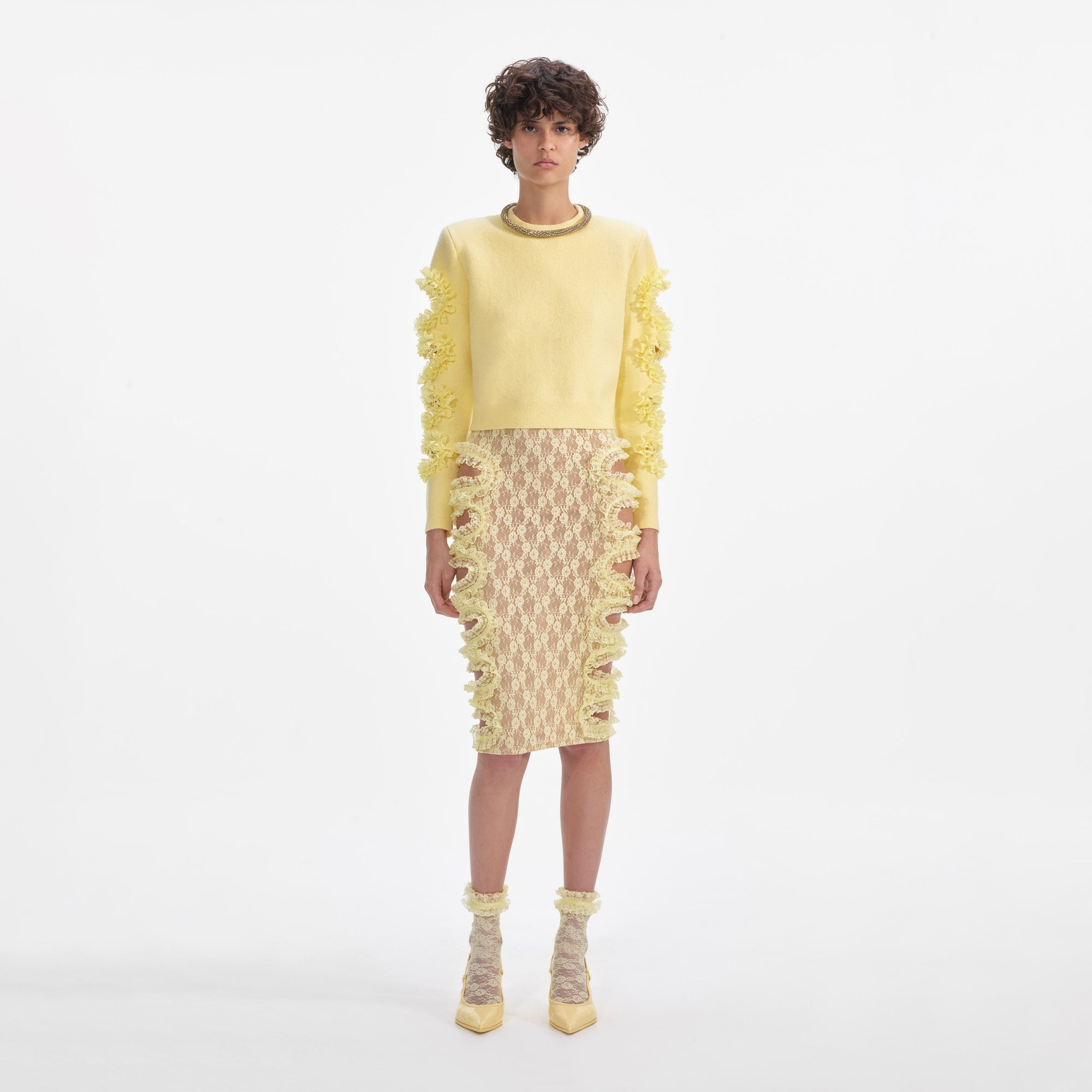 Front view of a woman wearing the Yellow Lace Cut Out Midi Skirt