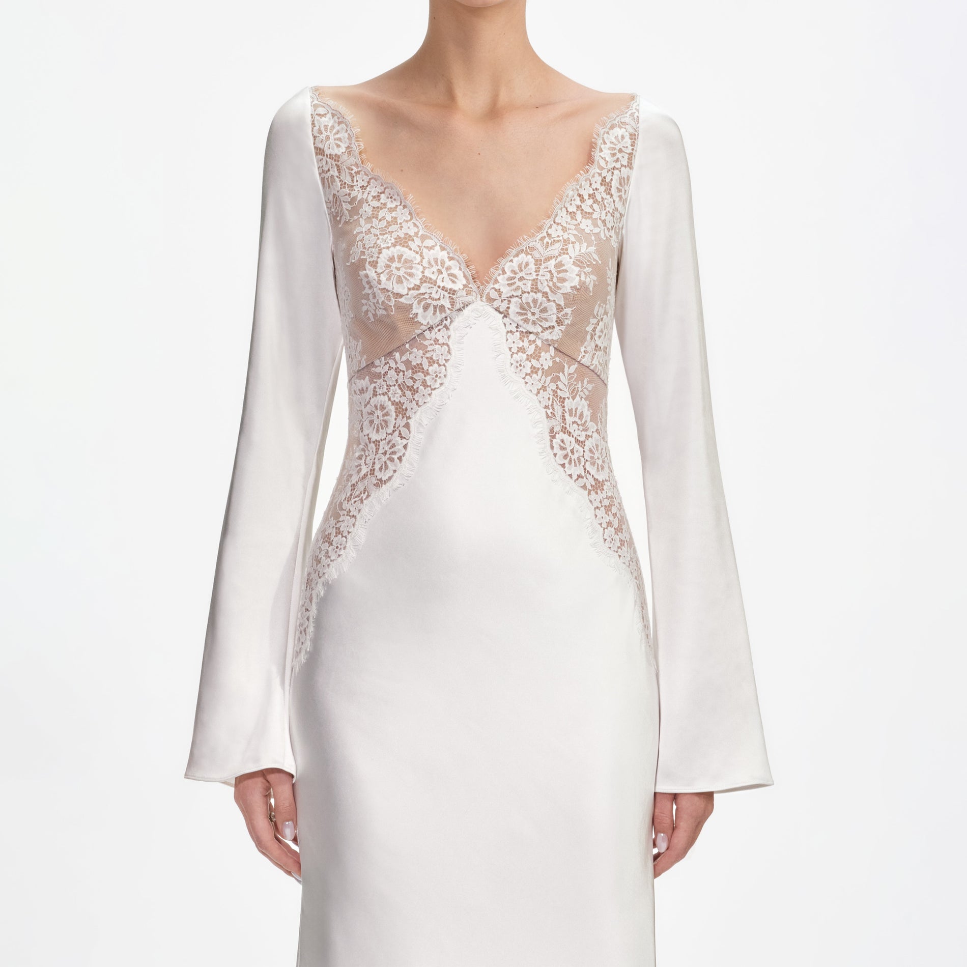 A close up of a woman wearing the White Lace Satin Long Sleeve Maxi Dress