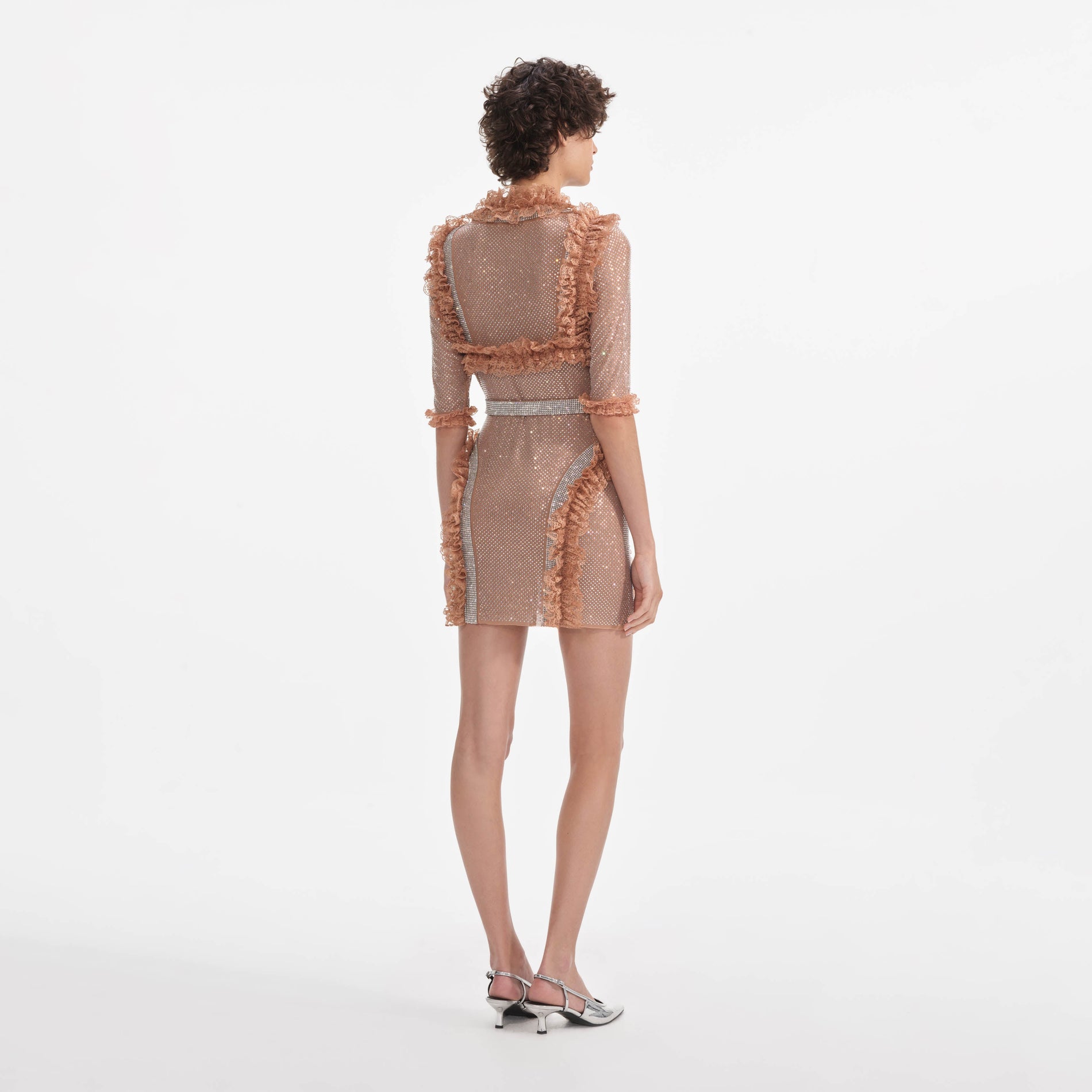 Back view of a woman wearing the Tan Rhinestone Mesh Ruffle Mini Dress