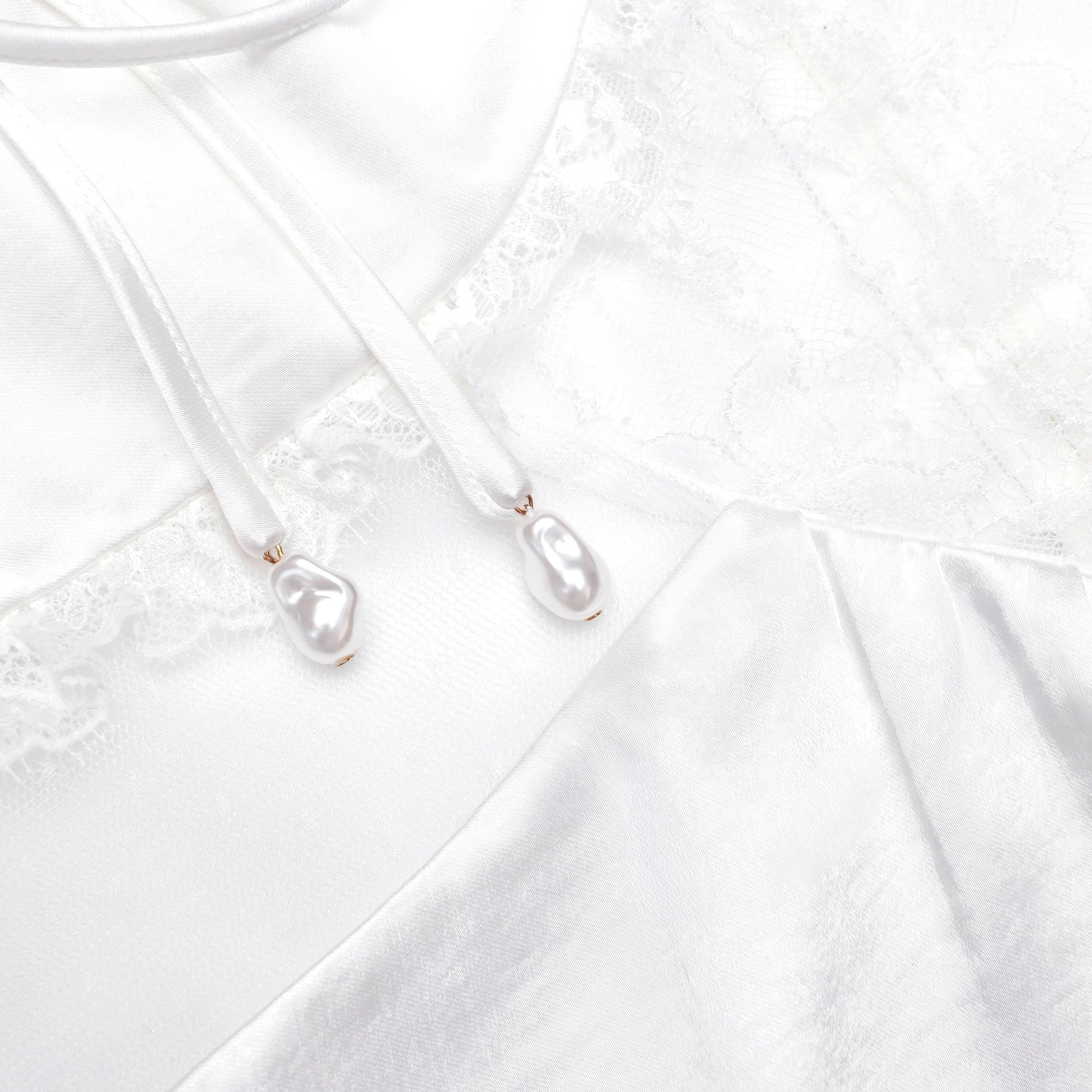 A close up of the fabric for the White Satin Lace Top