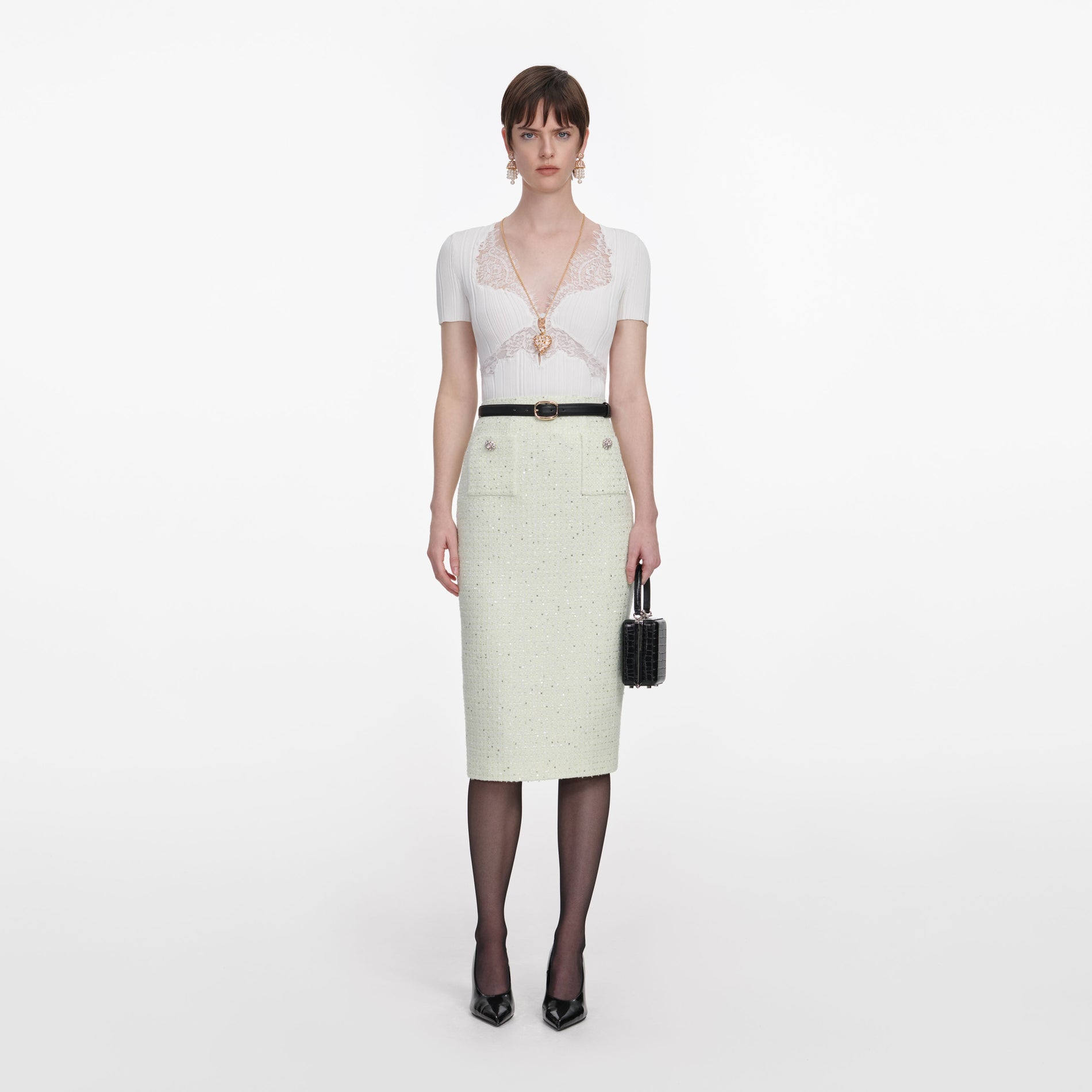 Front view of a woman wearing the Lime Boucle Midi Skirt