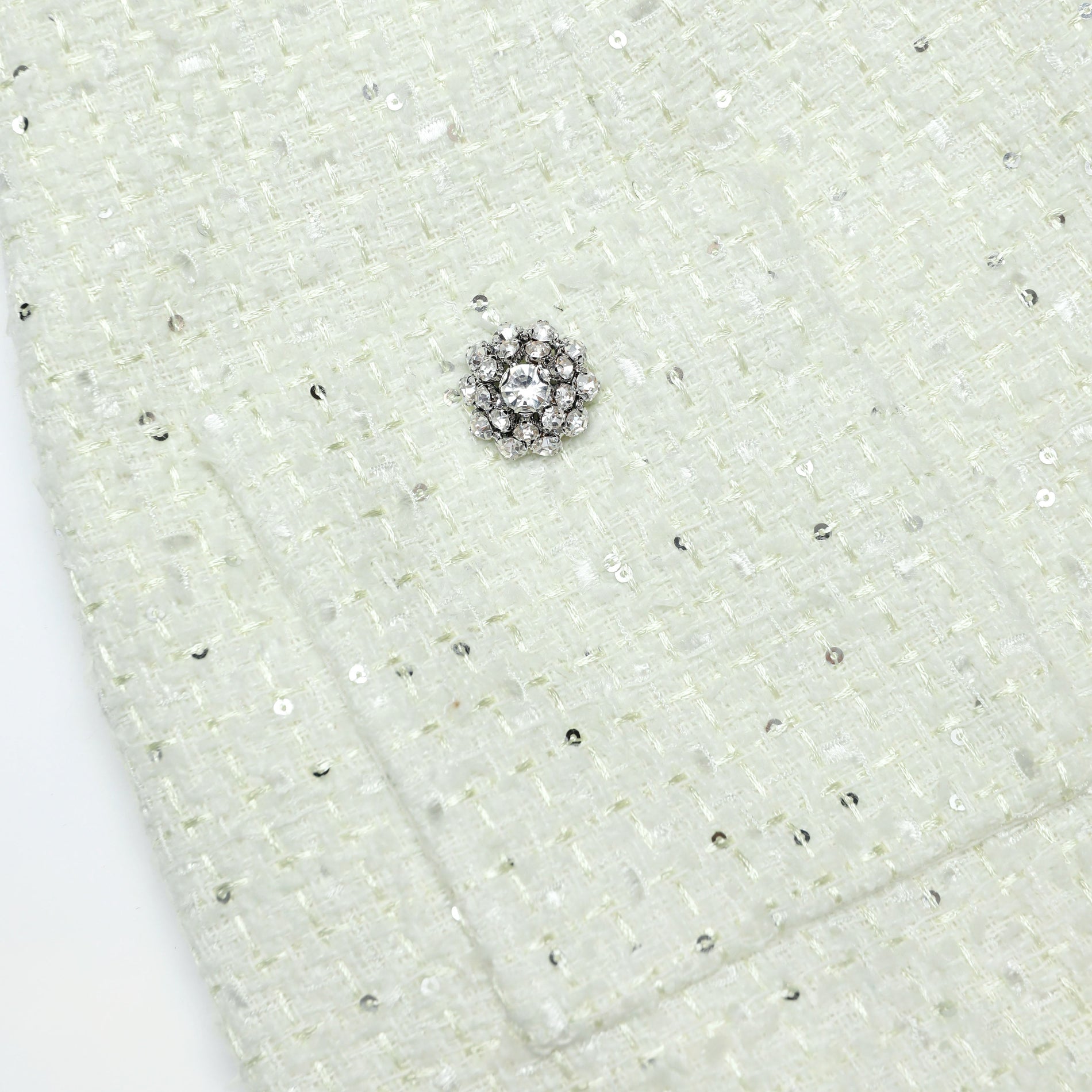A close up of a woman wearing the Lime Boucle Midi Skirt