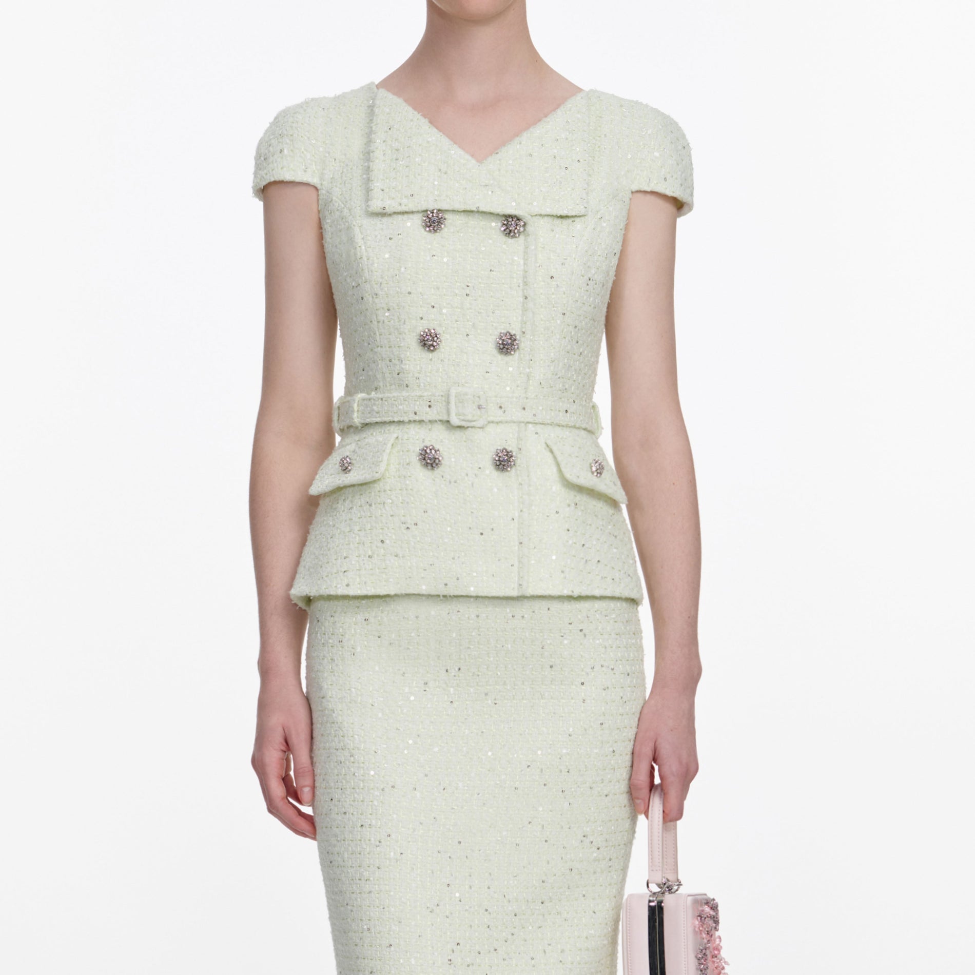 A close up of a woman wearing the Lime Boucle Midi Dress