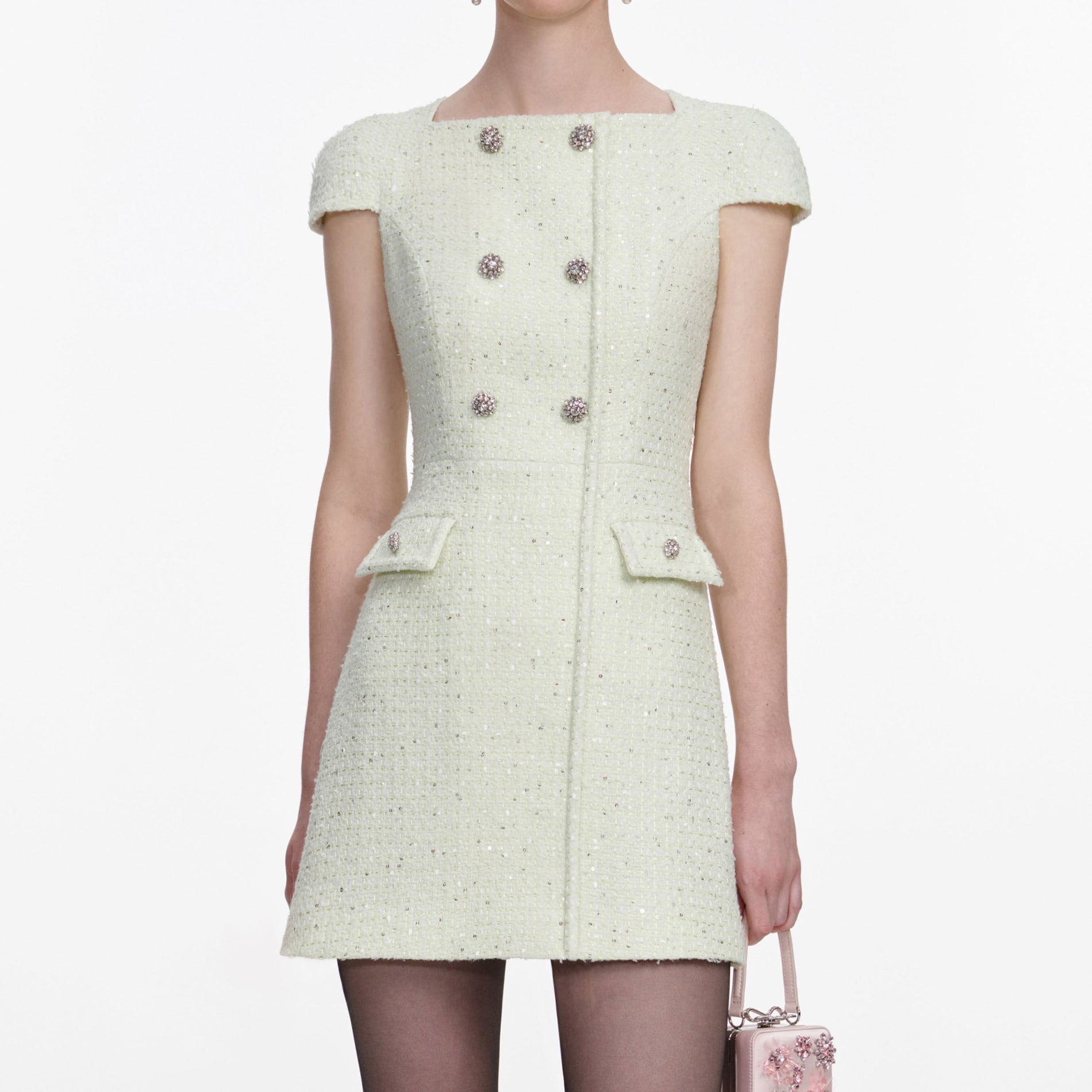 A close up of a woman wearing the Lime Boucle Mini Dress