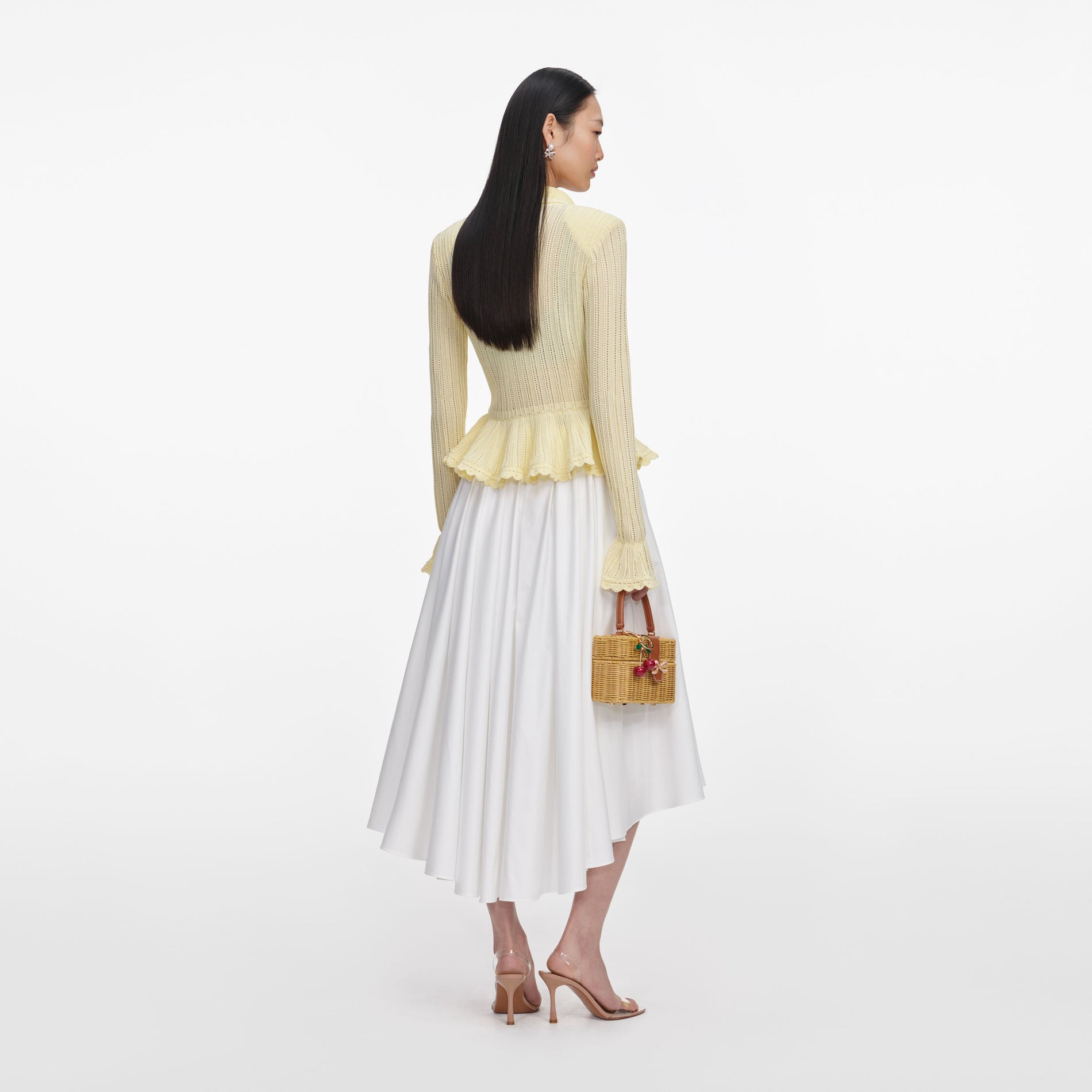 Back view of a woman wearing the Yellow Pointelle Cardigan