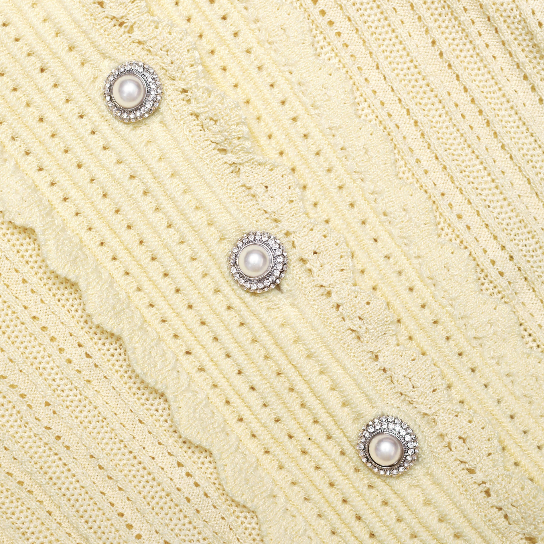 A close up of the fabric for the Yellow Pointelle Cardigan