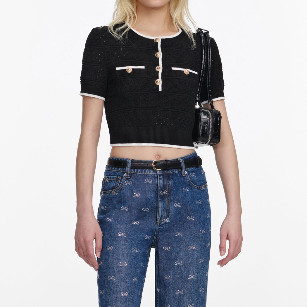 A close up of a woman wearing the Black Pointelle Knit Top