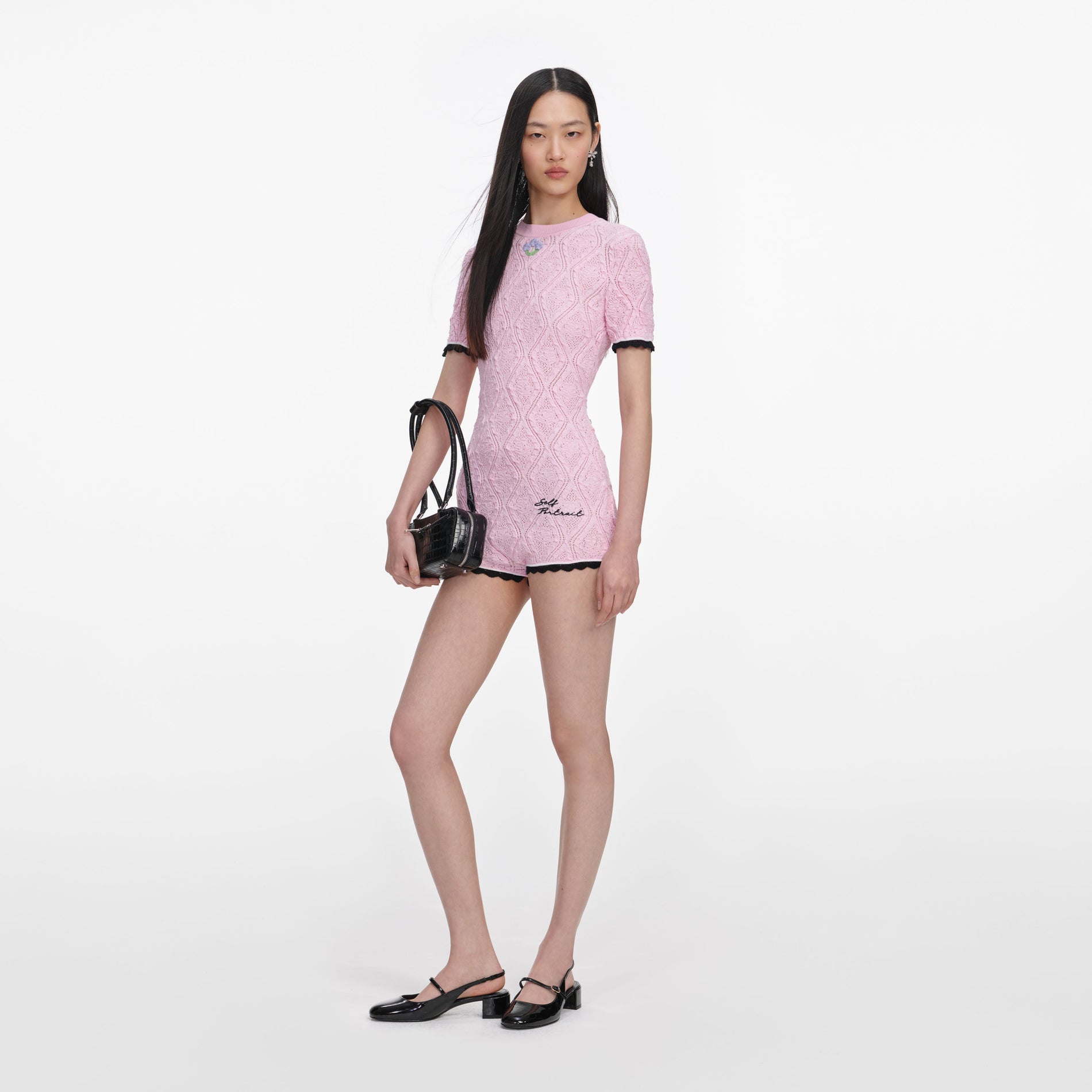 Side view of a woman wearing the Pink Pointelle Knit Playsuit