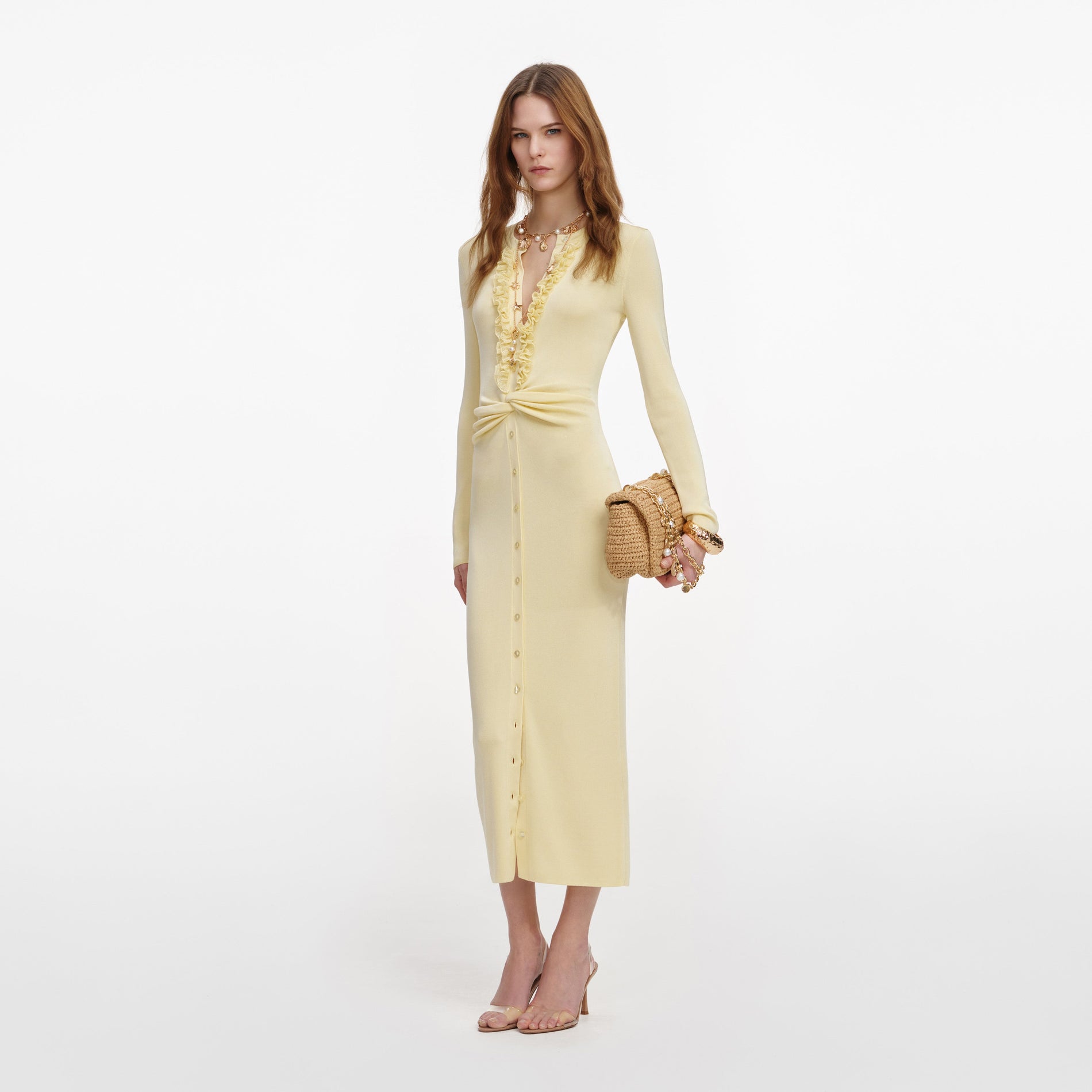 Side view of a woman wearing the Yellow Viscose Knit Ruffle Midi Dress