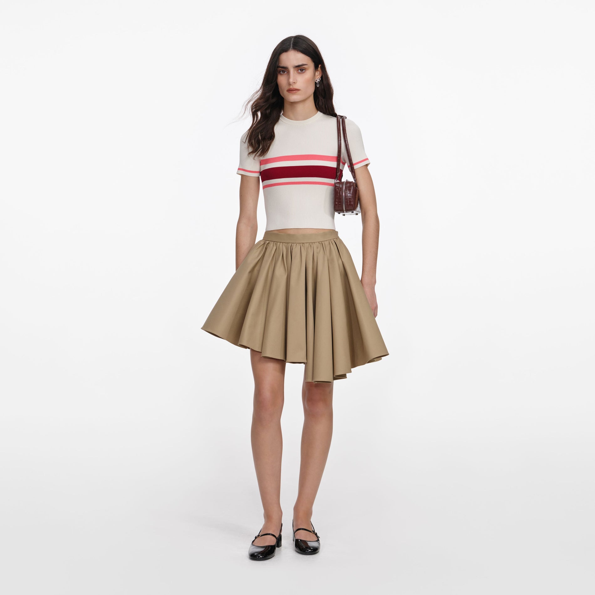 Front view of a woman wearing the Tan Cotton Mini Skirt