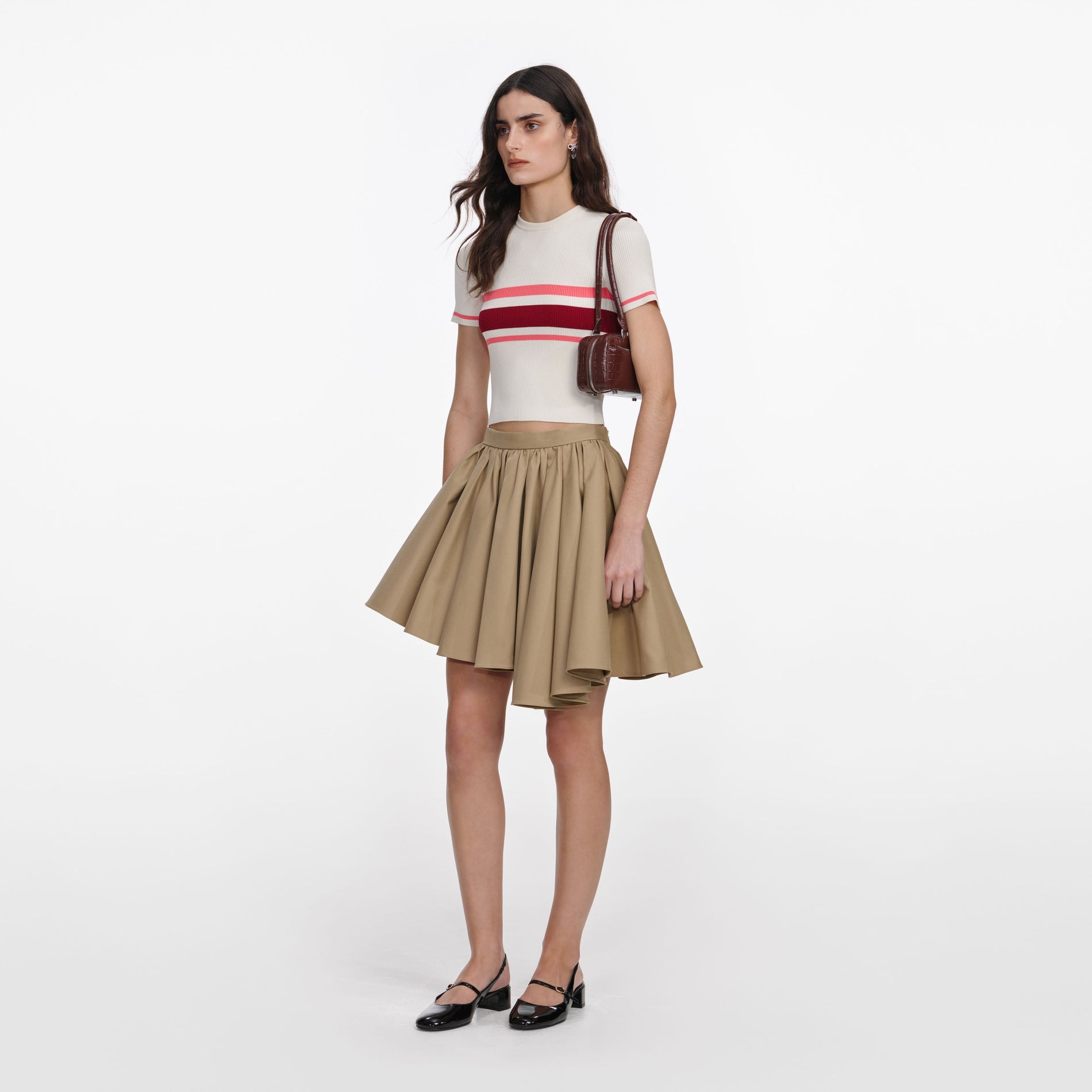 Side view of a woman wearing the Tan Cotton Mini Skirt