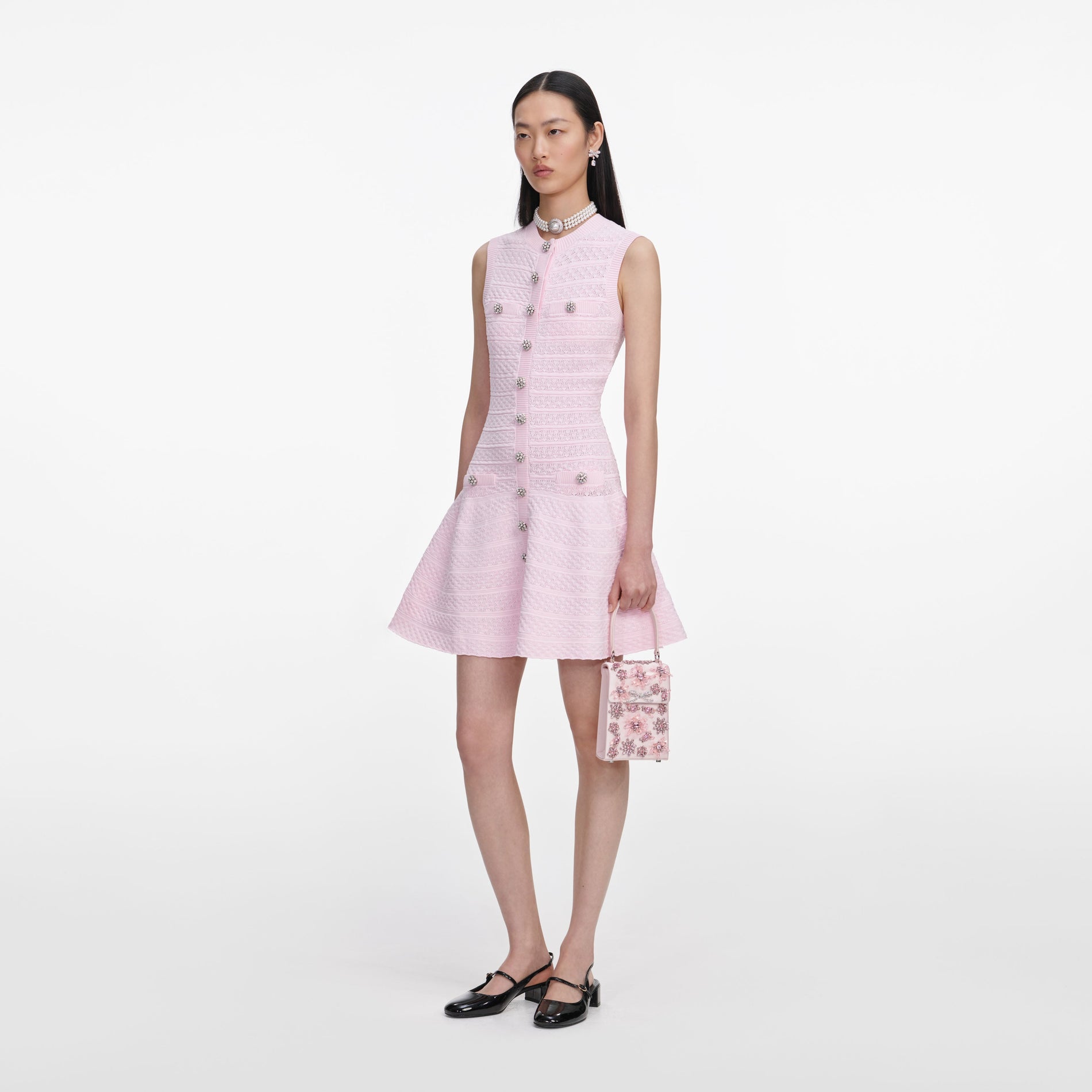 Side view of a woman wearing the Pink Pointelle Diamante Knit Mini Dress