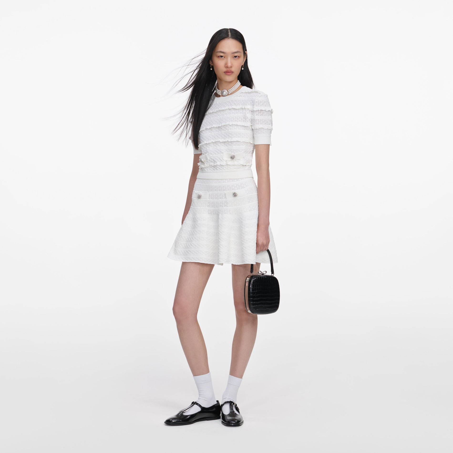 Side view of a woman wearing the White Pointelle Knit Top