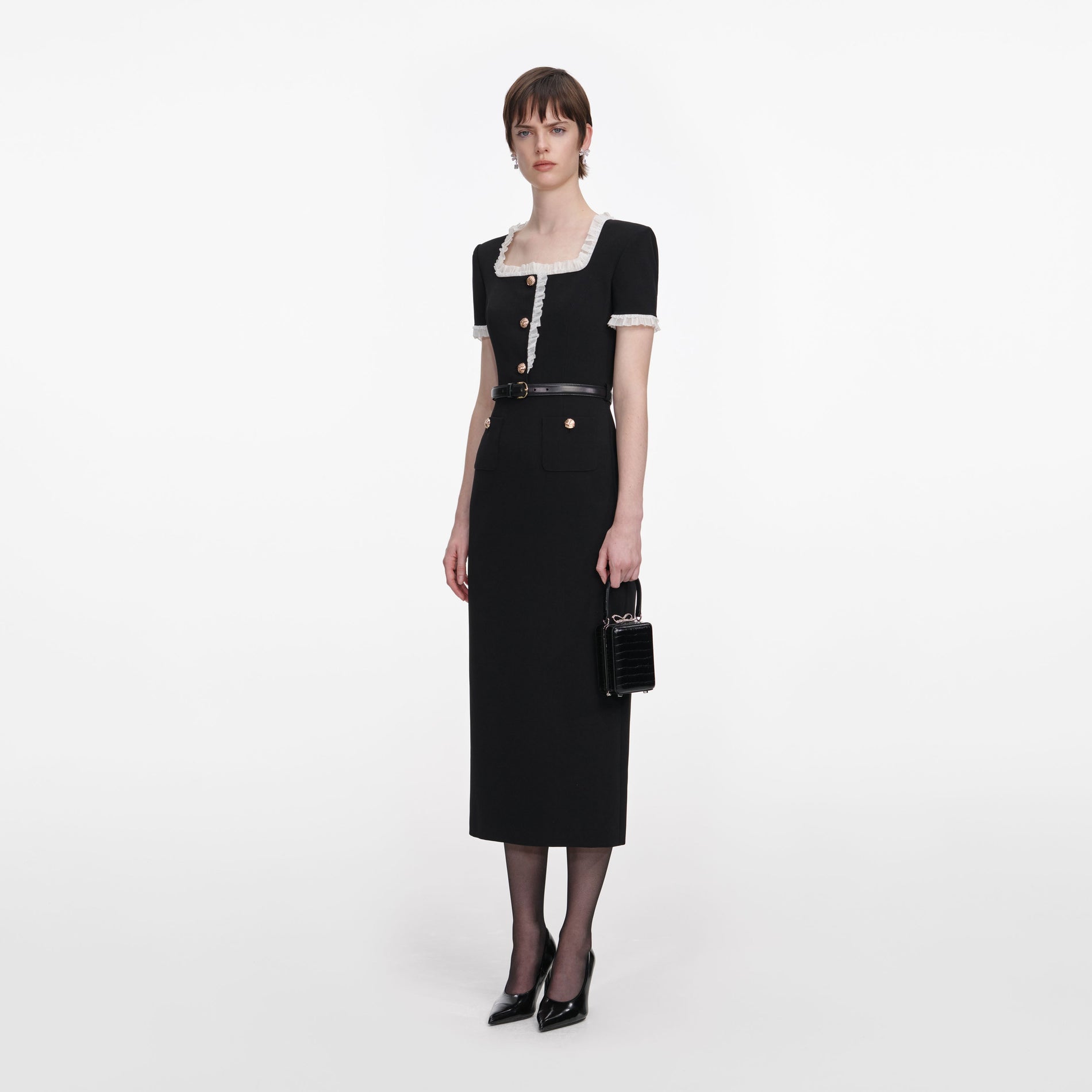 Side view of a woman wearing the Black Crepe Contrast Frill Midi Dress