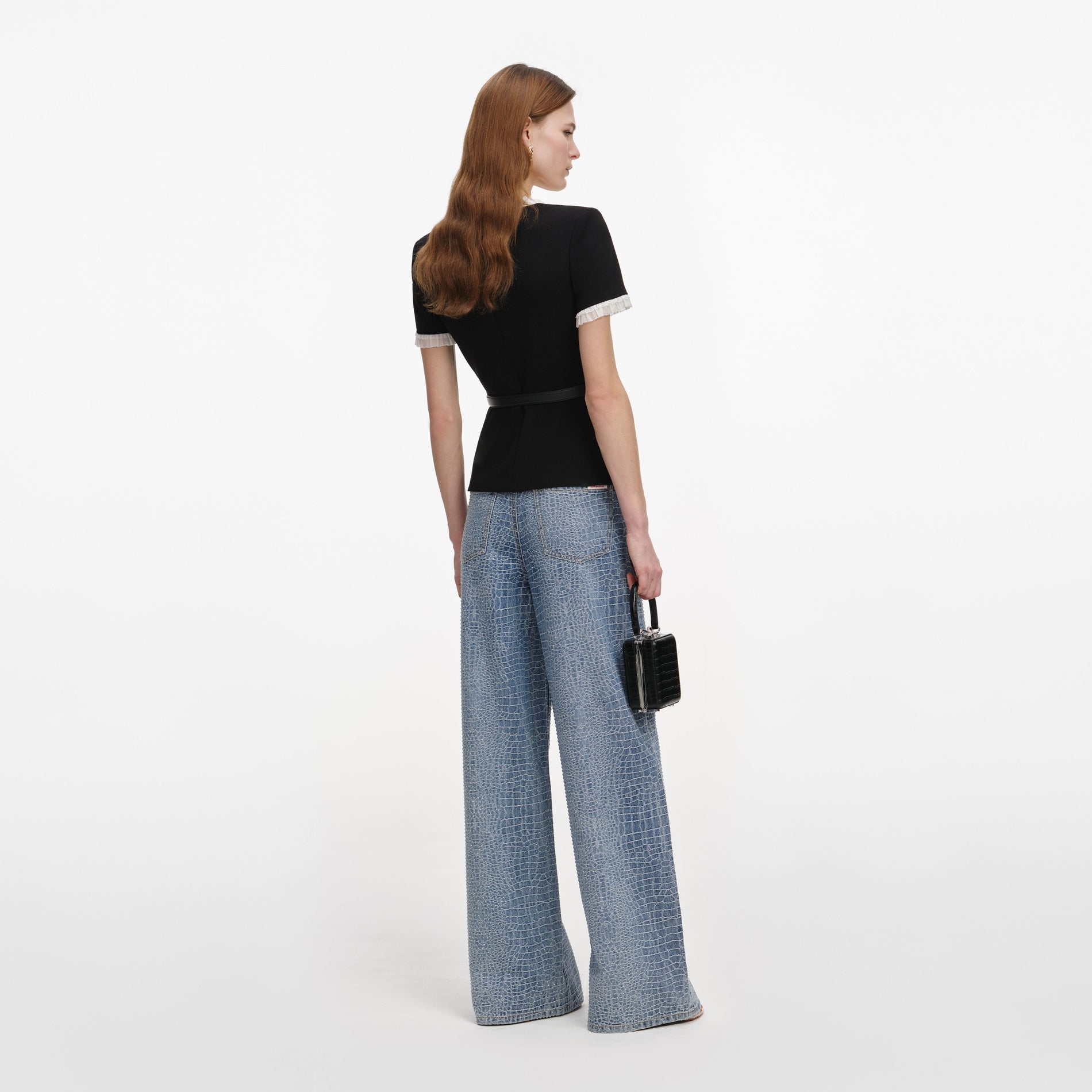 Back view of a woman wearing the Black Crepe Contrast Frill Top