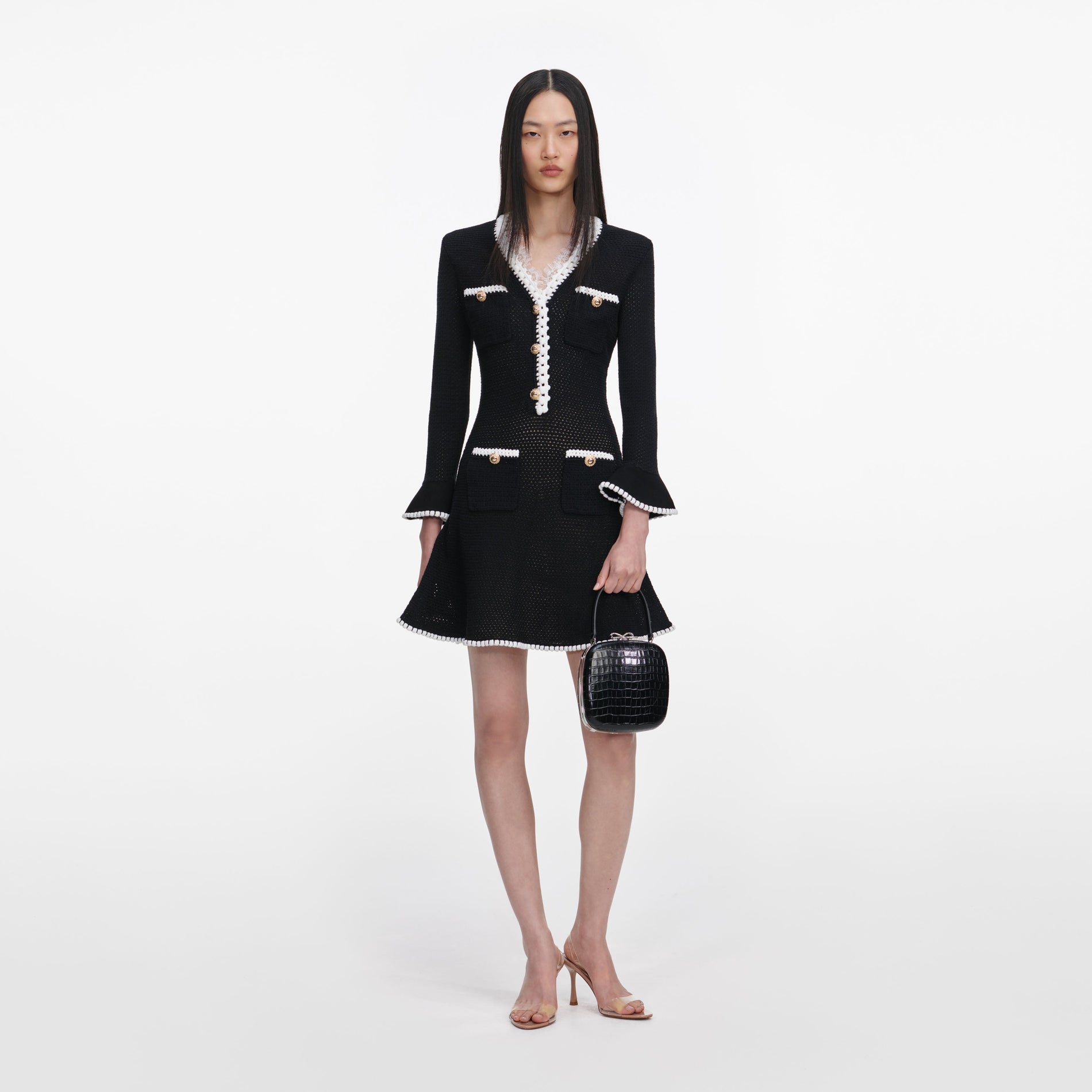 Front view of a woman wearing the Black Lace Trim Knit Mini Dress