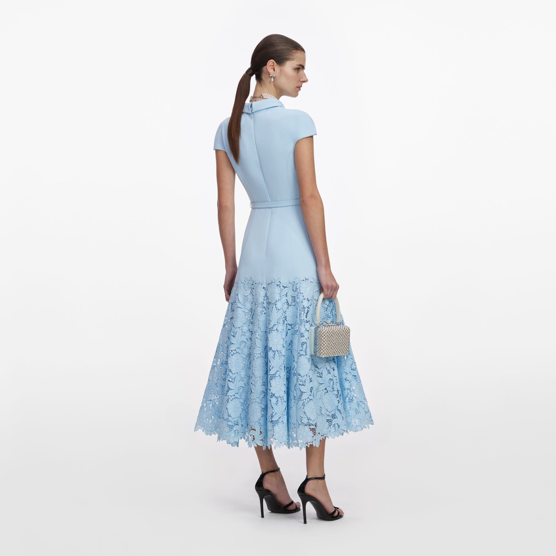Back view of a woman wearing the Blue Crepe Lace Midi Dress