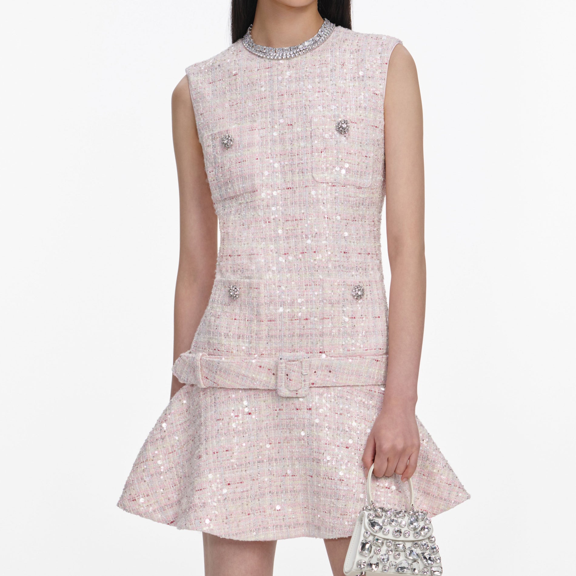 A close up of a woman wearing the Pink Sequin Boucle Belted Mini Dress