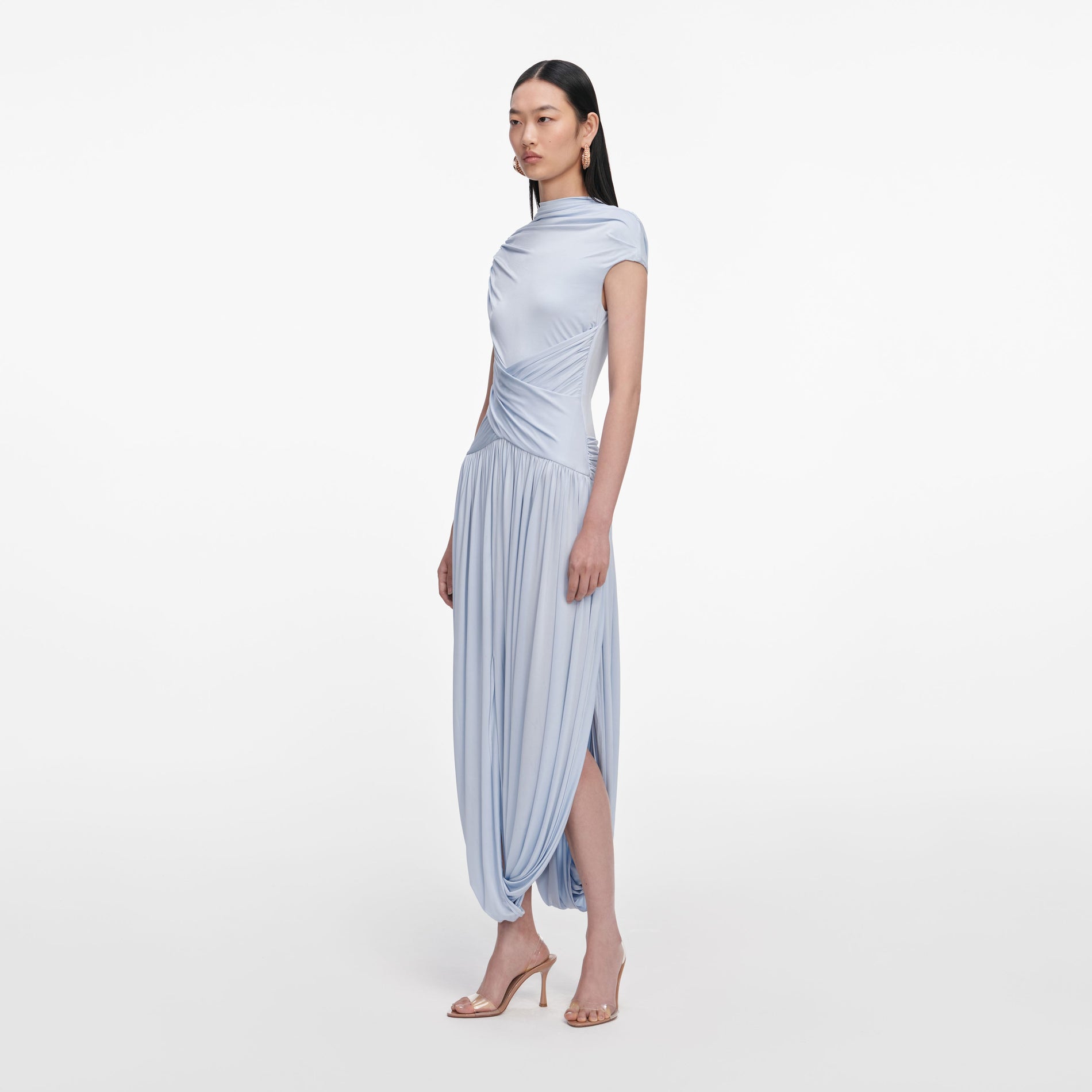 Side view of a woman wearing the Blue Jersey Gathered Midi Dress