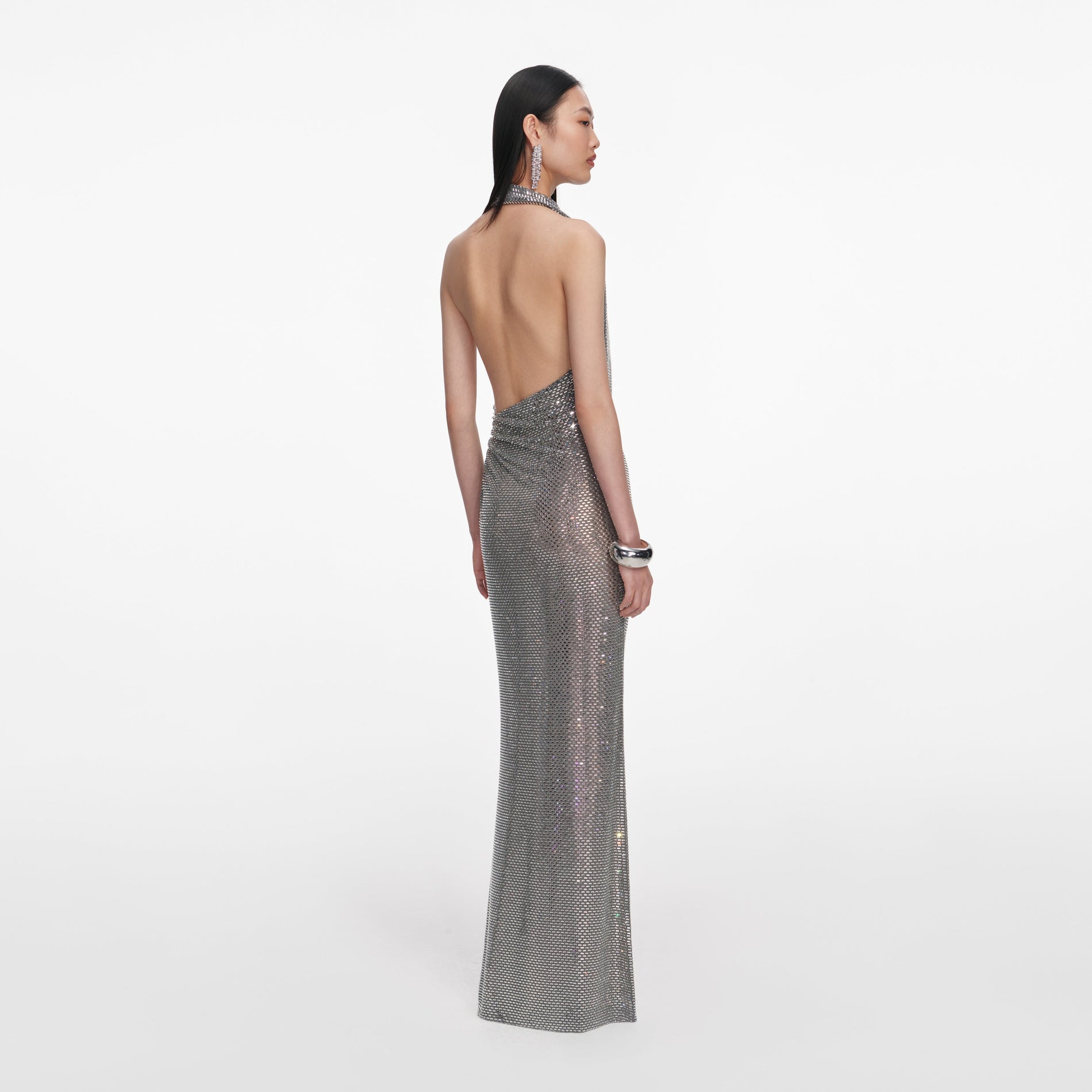 Back view of a woman wearing the Grey Rhinestone Drape Maxi Dress