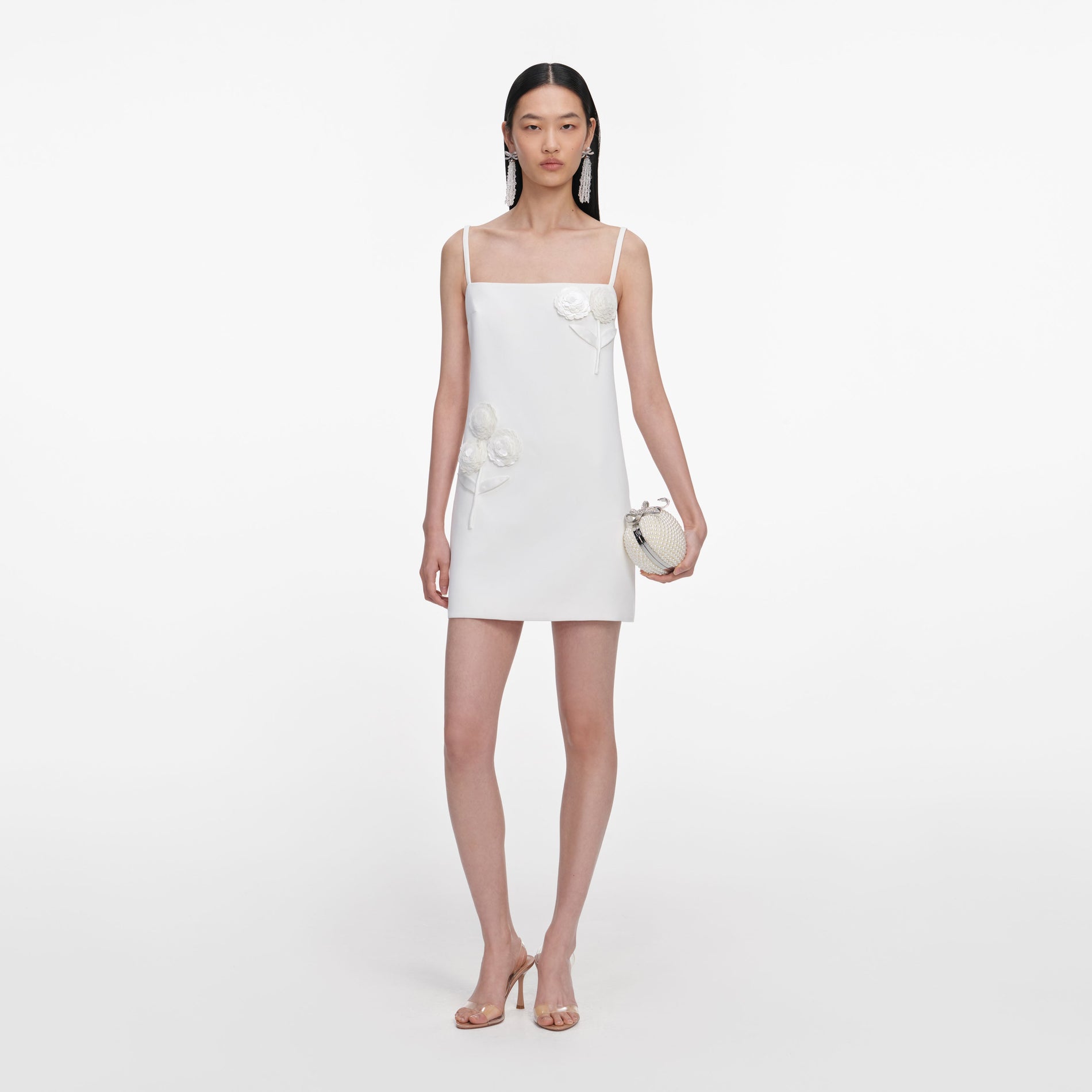 Front view of a woman wearing the White Crepe 3D Sequin Flower Mini Dress