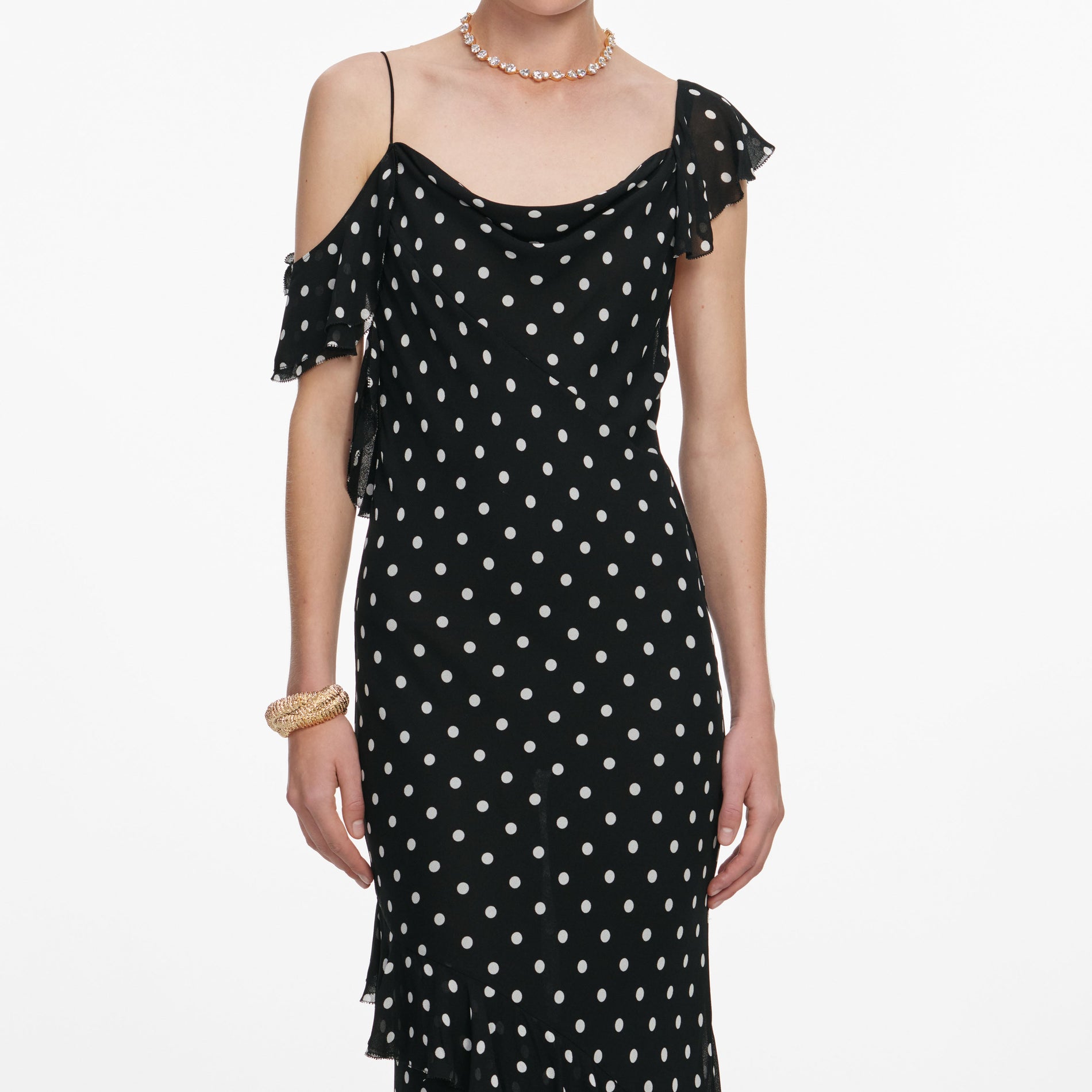 A close up of a woman wearing the Black Polka Dot Georgette Maxi Dress