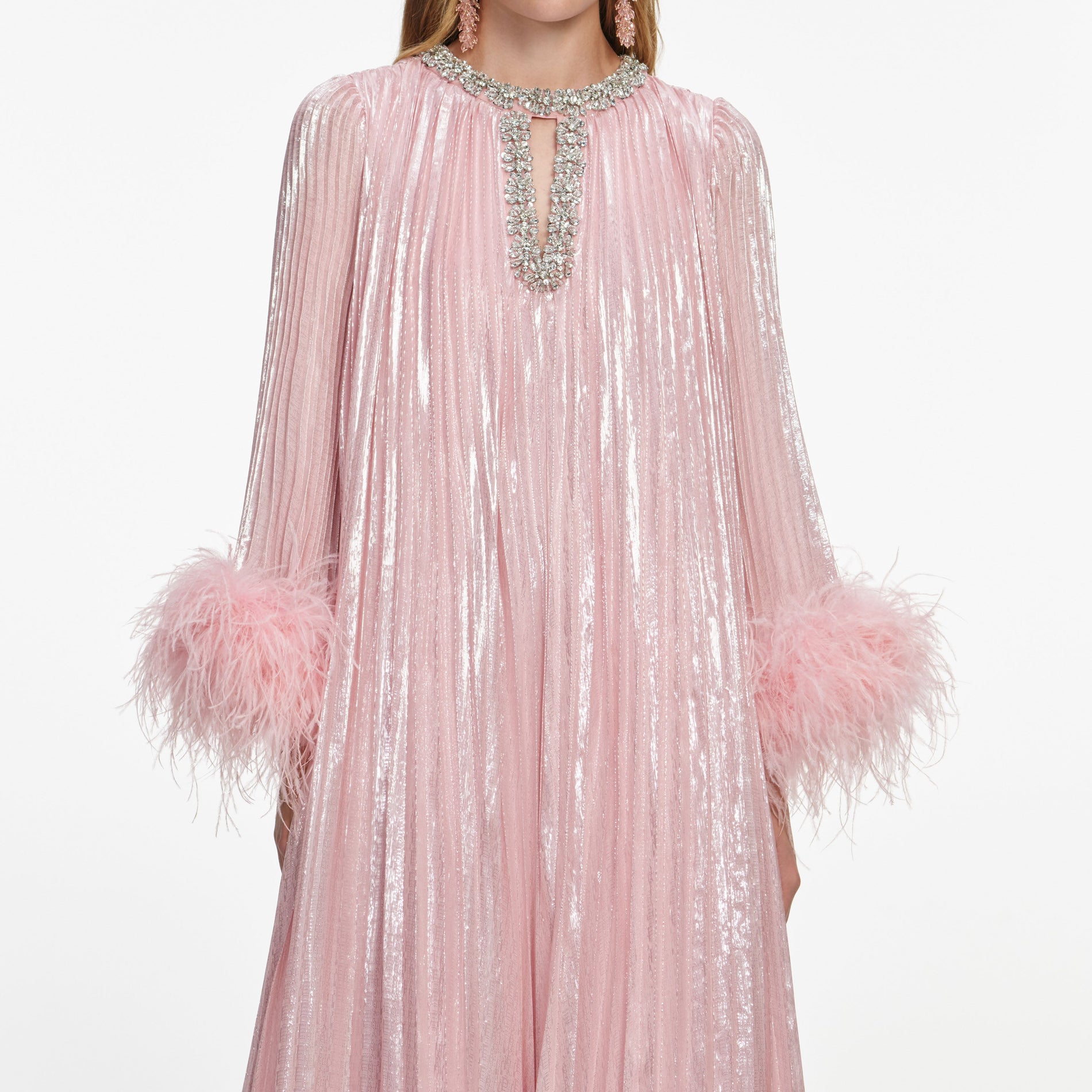 A close up of a woman wearing the Pink Metallic Chiffon Feather Midi Dress