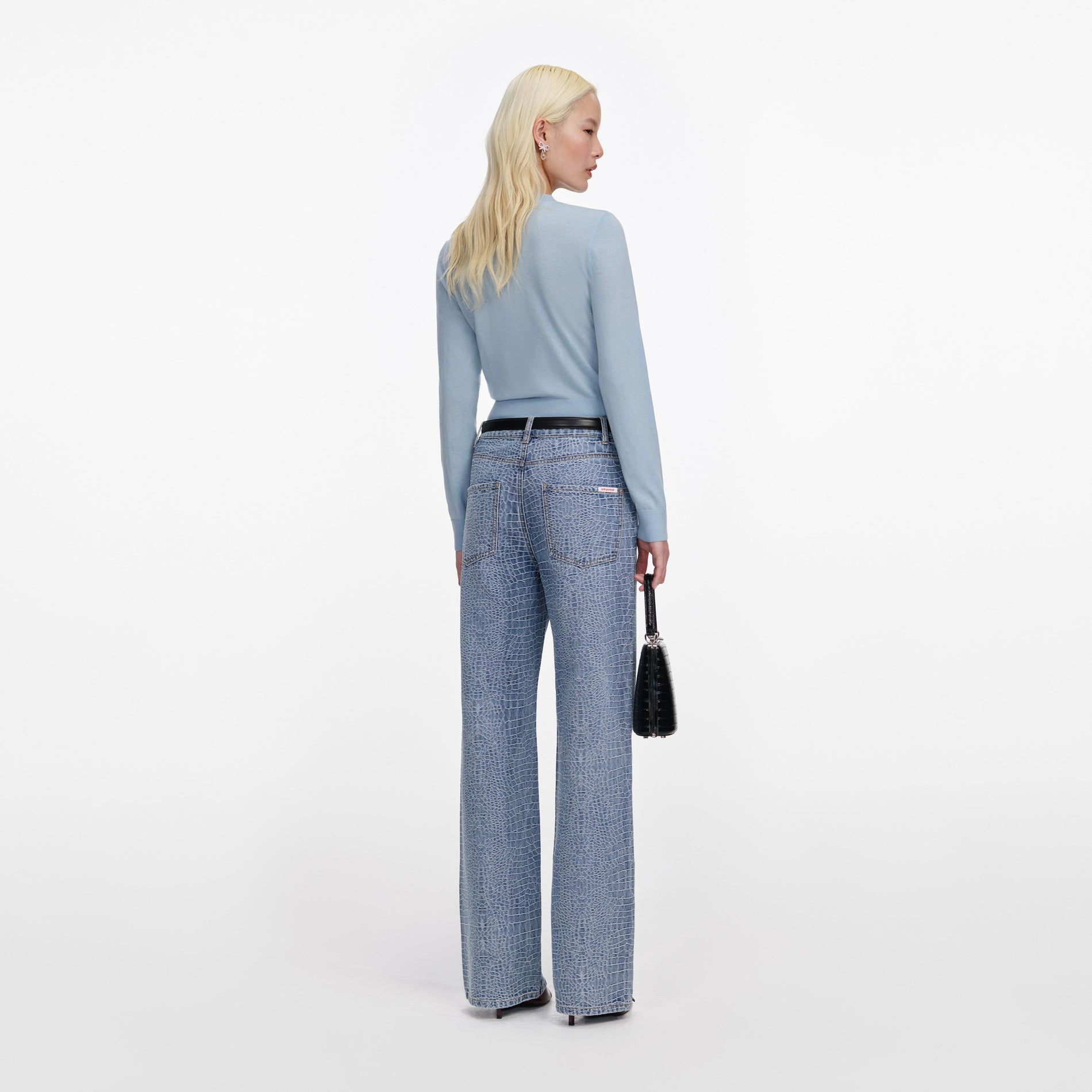 Back view of a woman wearing the Blue Rose Wool Jumper