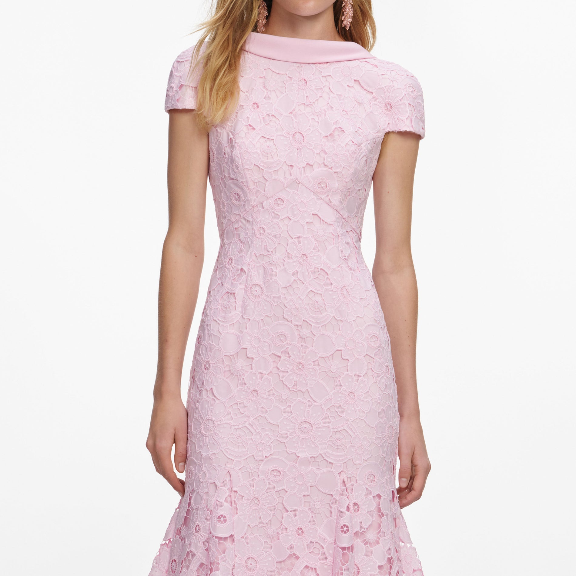 A close up of a woman wearing the Pink Lace Scoop Back Midi Dress