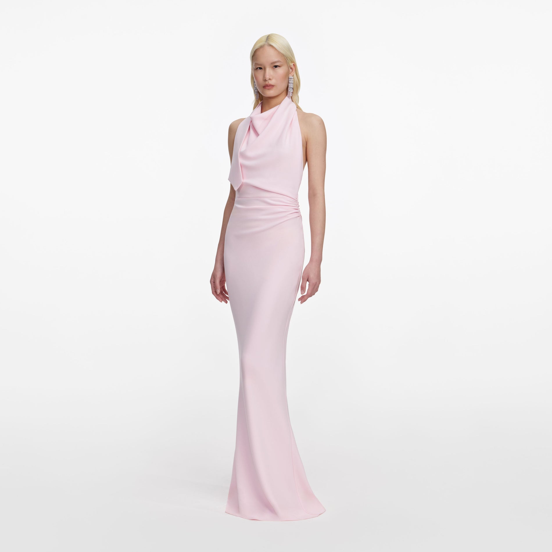Side view of a woman wearing the Pink Crepe Halter Neck Maxi Dress