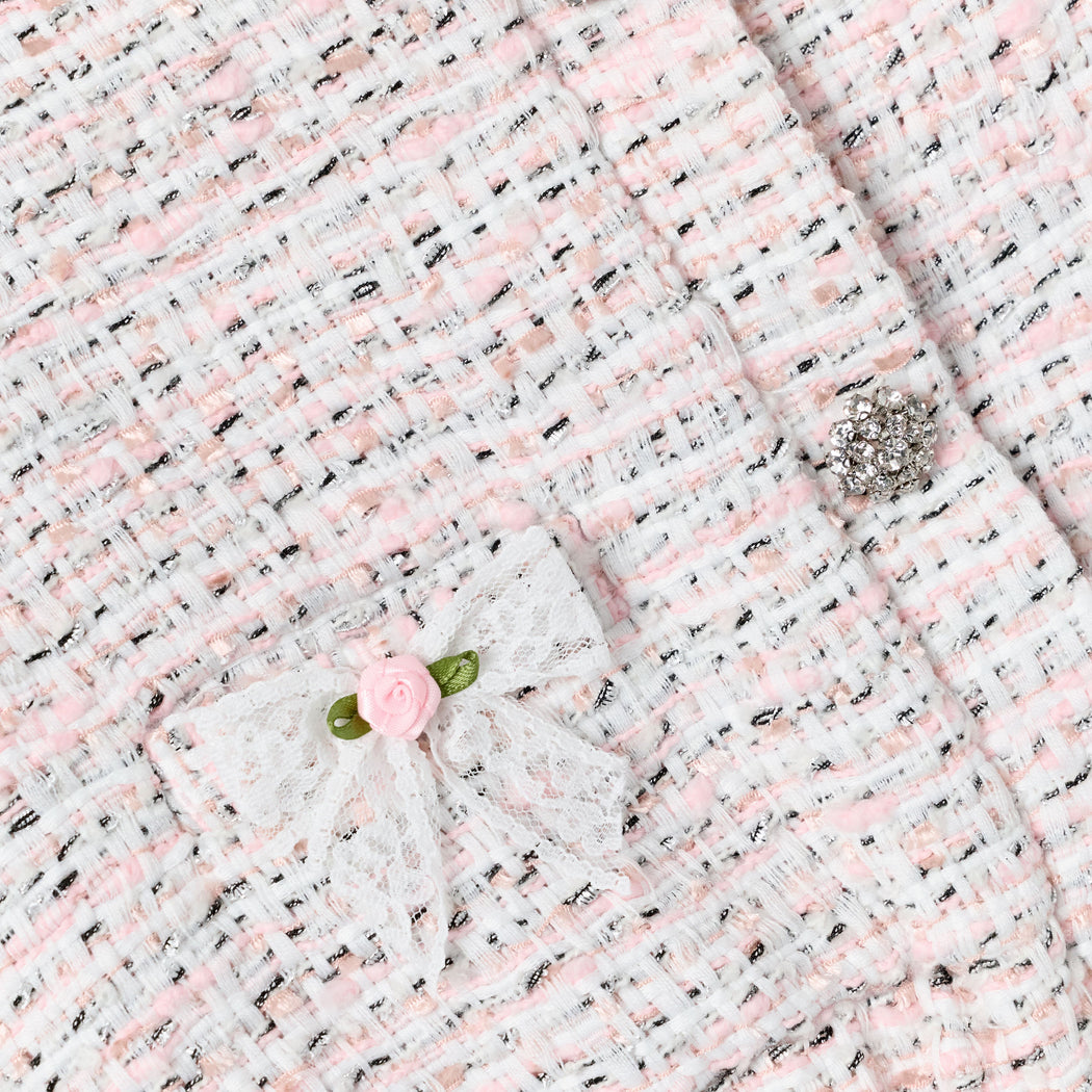 White, pink, and black tweed fabric with a lace bow, pink rose, and a rhinestone button