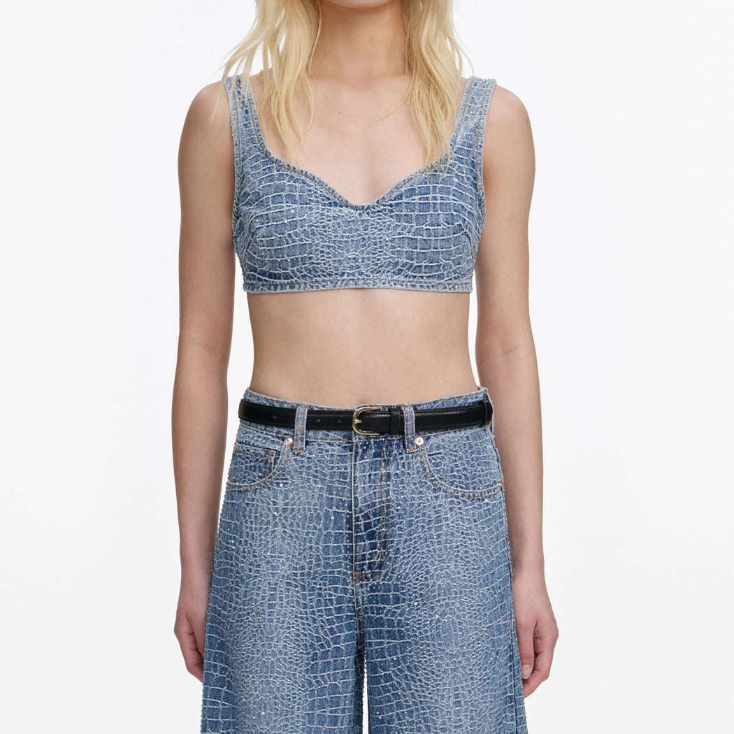 A close up of a woman wearing the Rhinestone Croc Effect Denim Bralette