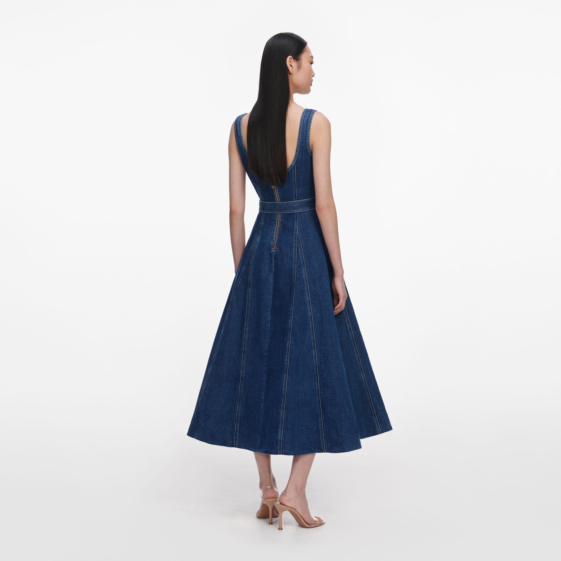 Back view of a woman wearing the Denim Flared Belted Midi Dress