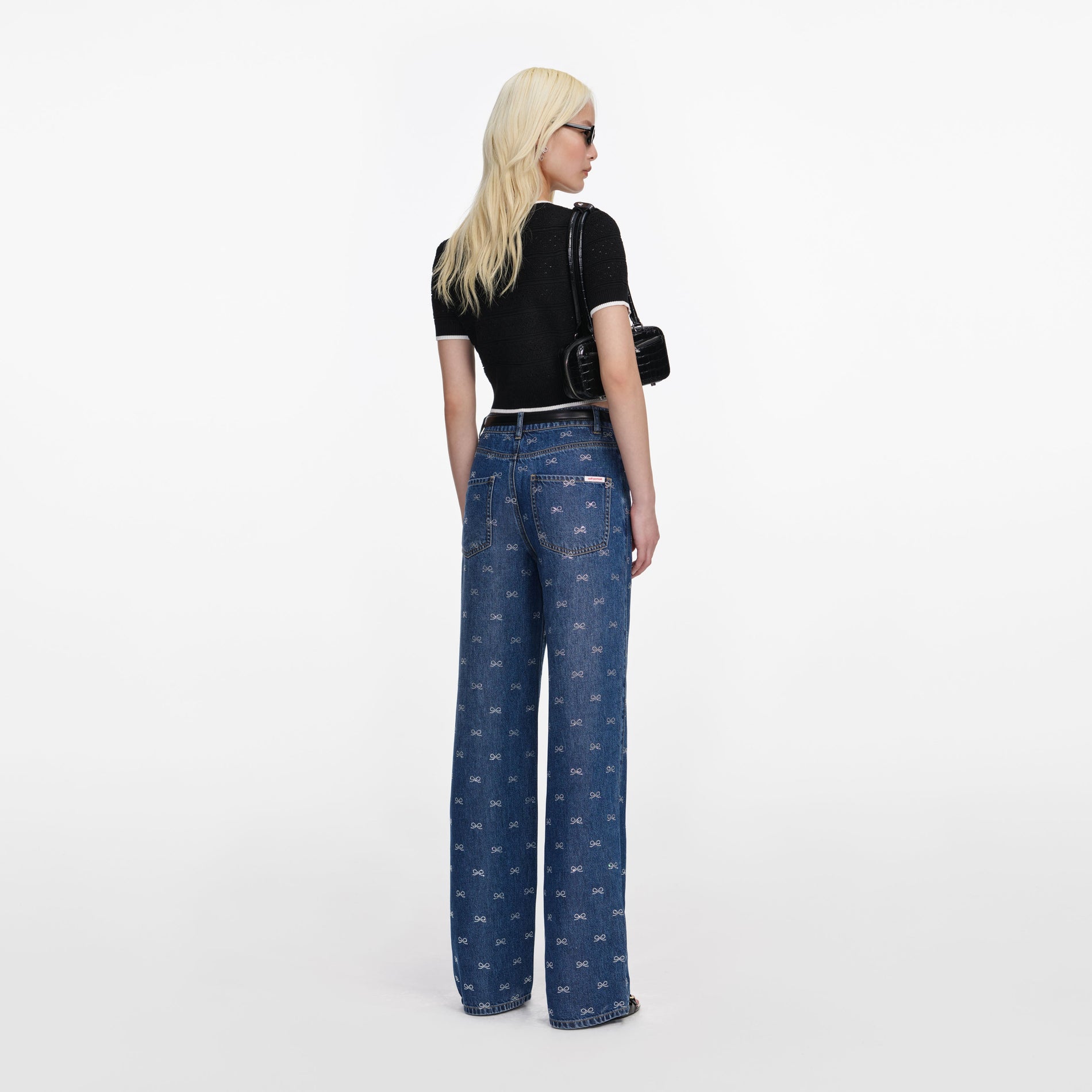 Back view of a woman wearing the Lightweight Bow Embellished Jeans