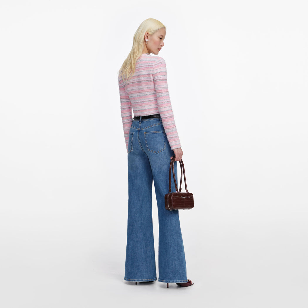 Back view of a woman wearing the Mid Blue Flared Jeans