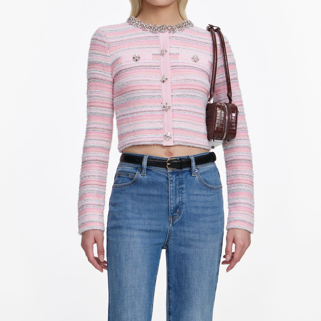 A close up of a woman wearing the Mid Blue Flared Jeans