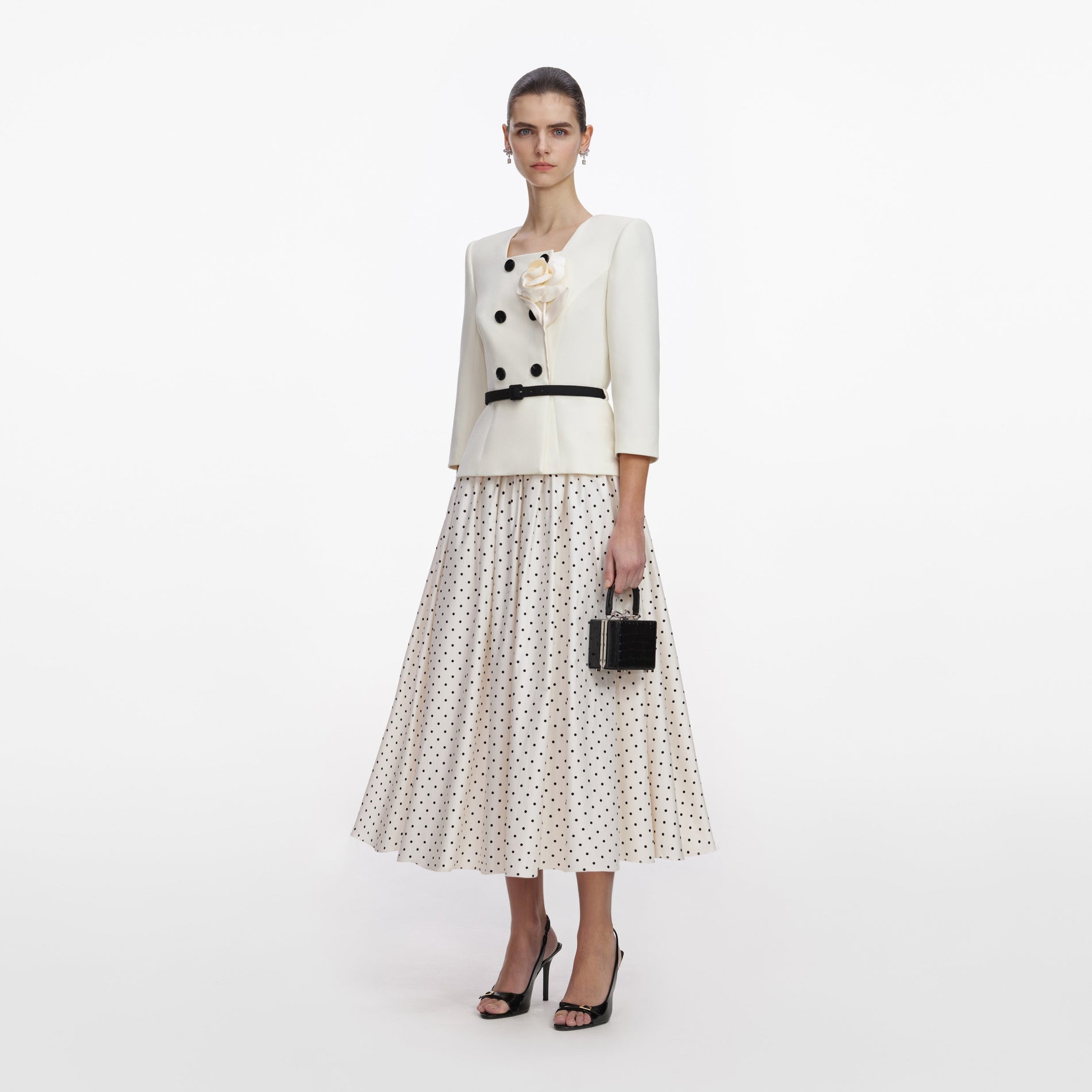 Side view of a woman wearing the Cream 3D Flower Polka Dot Midi Dress