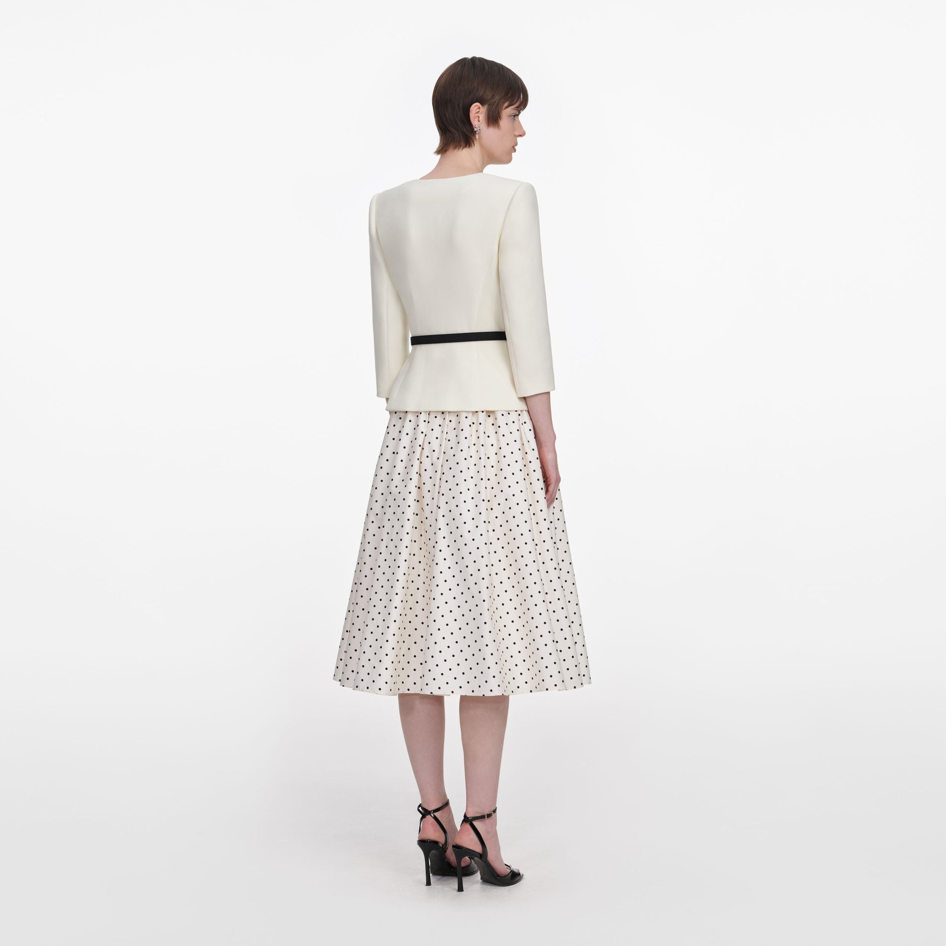 Back view of a woman wearing the Cream 3D Flower Polka Dot Midi Dress